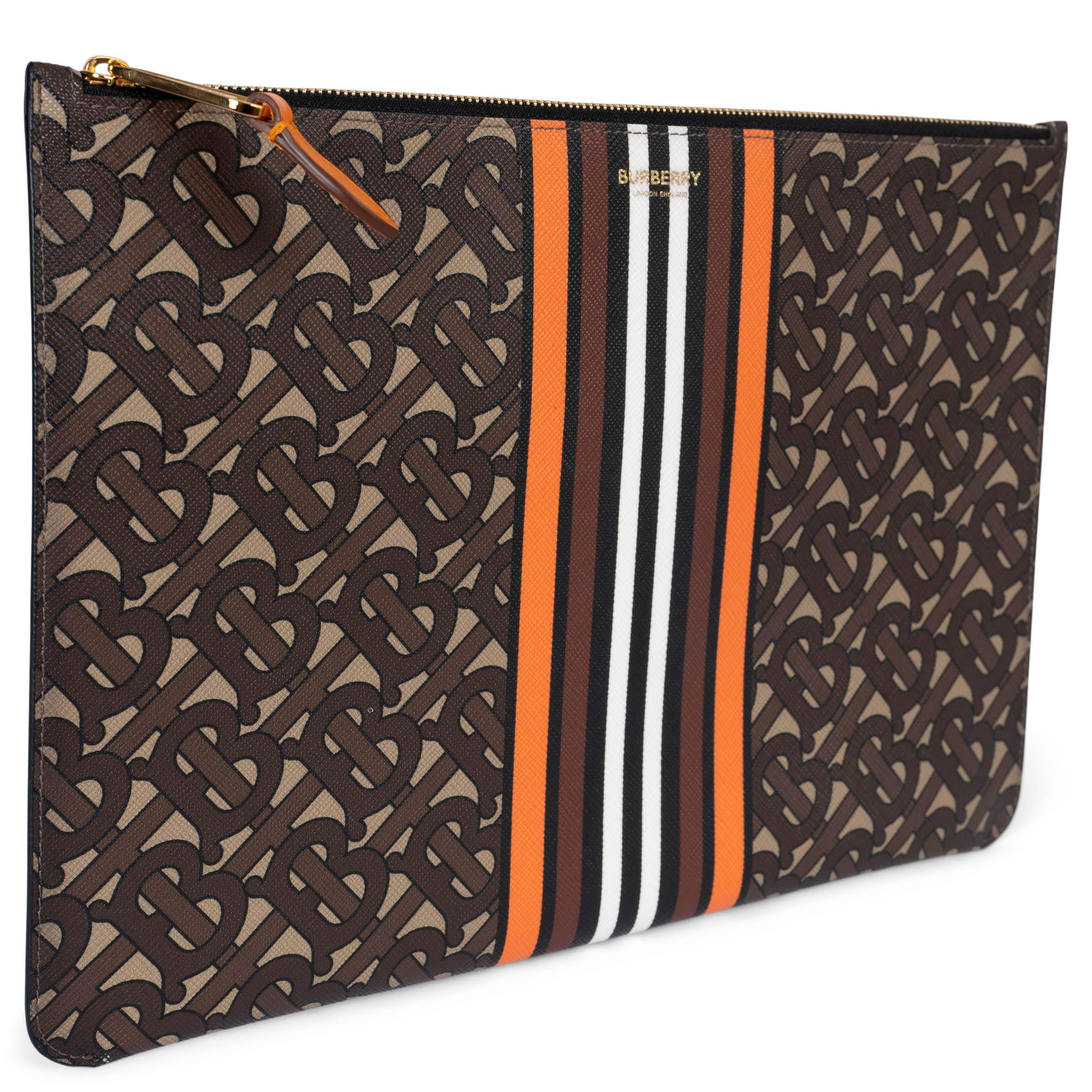 This 100% authentic Burberry zip pouch is crafted from various shades of brown TB Monogram e-canvas, accented with a striking orange, black, and white center stripe and finished with a gold leaf logo for a touch of elegance. It opens with a zipper