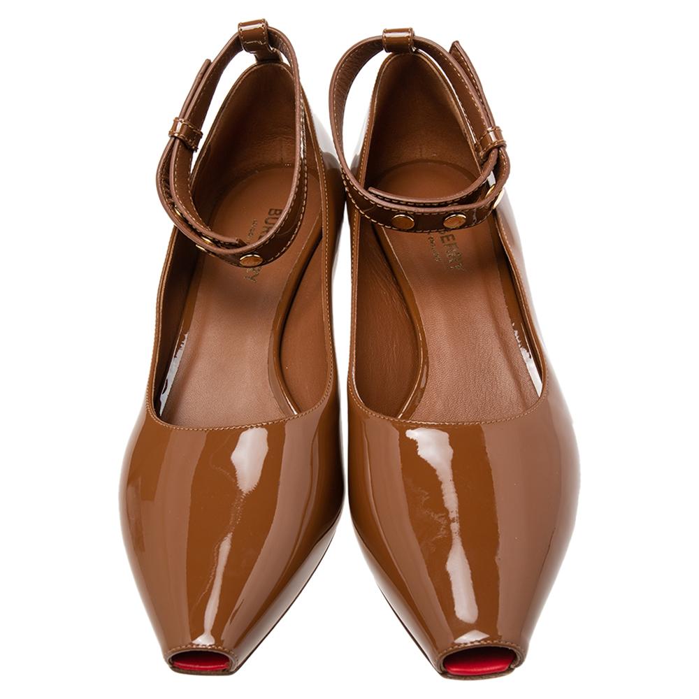 The chic pumps by Burberry define the label’s elegant charm and unique aesthetics. They are skillfully crafted from patent leather in a brown shade and characterized by luxe cuts and durable construction. These beauties are complete with peep-toes