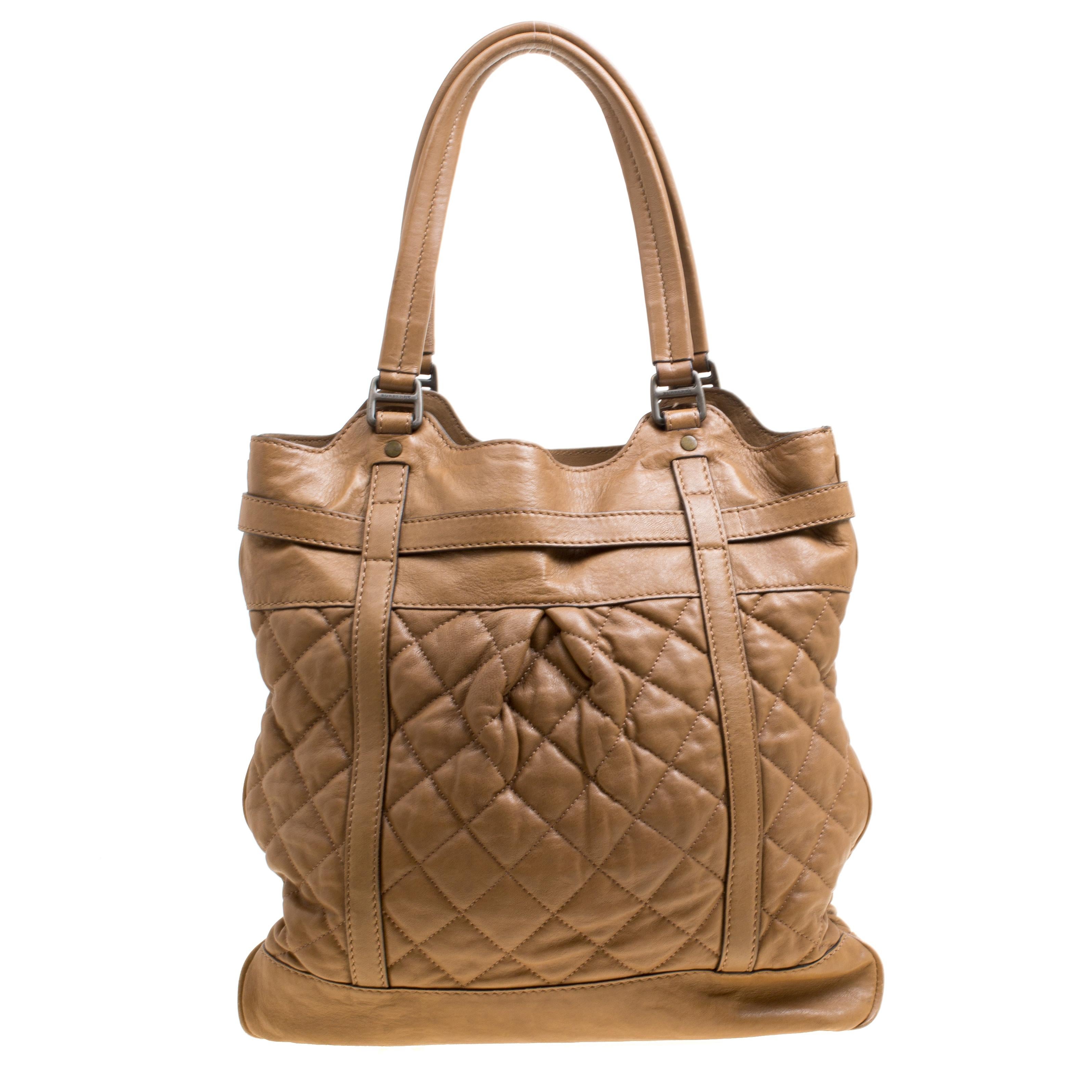 This beautiful, brown Burberry beauty will give your look a touch of class and elegance. It is crafted from leather and is adorned with a quilted pattern along with a buckled belt strap on the front. The well-designed exterior is coupled with