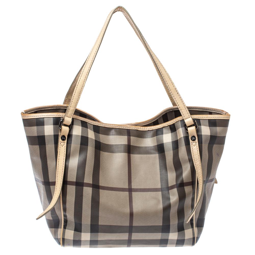 This Canterbury tote from Burberry is crafted from coated canvas and leather in their signature Smoke House Check. It comes with dual leather handles and a canvas-lined interior that can hold all your daily necessities. Simple in design, the bag is