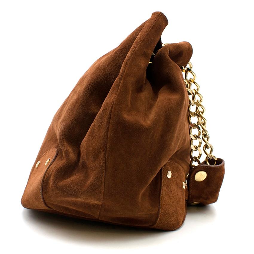 Burberry Brown Suede Bucket Shoulder Bag

- Chocolate brown suede bucket bag
- Gold-tone metal chain shoulder straps with matching brown suede shoulder pads for comfort which can be removed if desired
- Gold-tone hardware
- Metal logo on the front
-