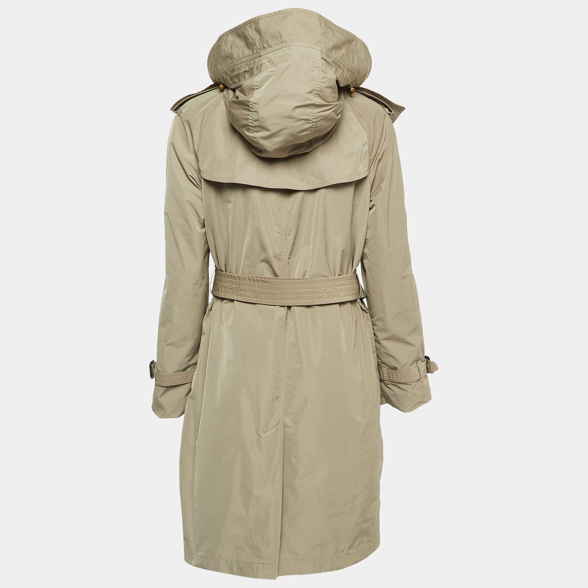The Burberry trench coat is an iconic fashion staple. Crafted from durable fabric, it features a classic double-breasted design, signature check lining, adjustable belt, and versatile brown hue. This timeless piece combines style and functionality