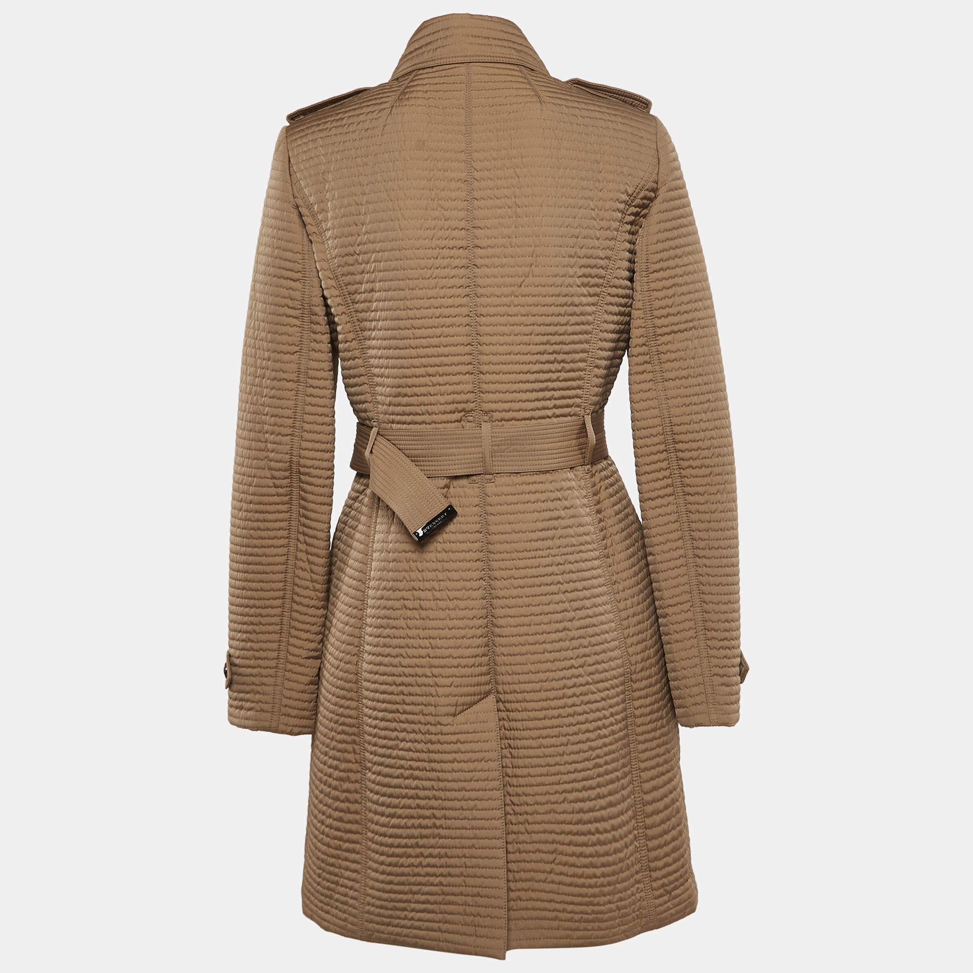 Crafted by Burberry, this exquisite mid-length coat exudes refinement with its rich brown hue and quilted design. The double-breasted silhouette adds a touch of timeless elegance, while the synthetic material ensures durability and weather