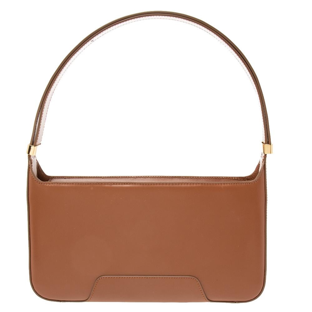 Burberry's brown leather shoulder bag is a knowing investment piece that's on-trend now, too. It's finished with an elegant gold-tone metal TB plaque as well as a shoulder strap so it can be worn in a number of different ways. With more room inside