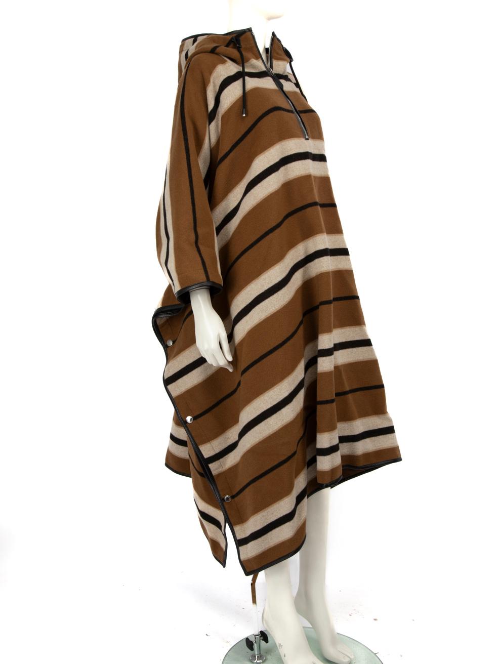CONDITION is Very good. Minimal wear to the poncho is evident. Small scratches to the leather on both of the adjustable toggles and missing composition label. The popper still include plastic wrap over protecting them on this used Burberry designer