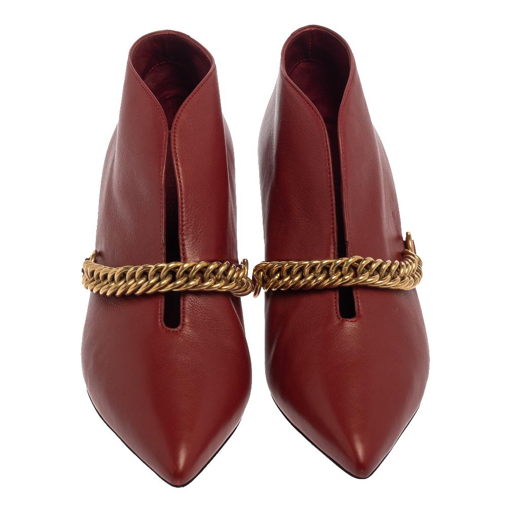How can one not fall in love with these gorgeous booties from Burberry! Crafted from leather, these burgundy ankle booties feature pointed toes and an open slit detail along with gold-tone chain-link embellishment on the vamps. They are elevated on