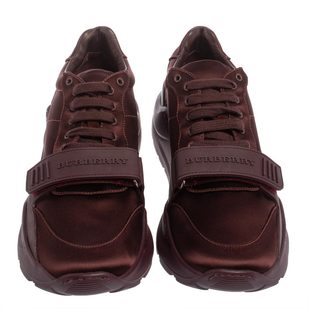 These burgundy sneakers from Burberry are fashioned from a combination of rubber and satin into a stylish low-top silhouette. The Regis pair comes with lace-up vamps, velcro straps with brand name details, and durable rubber soles. The sneakers