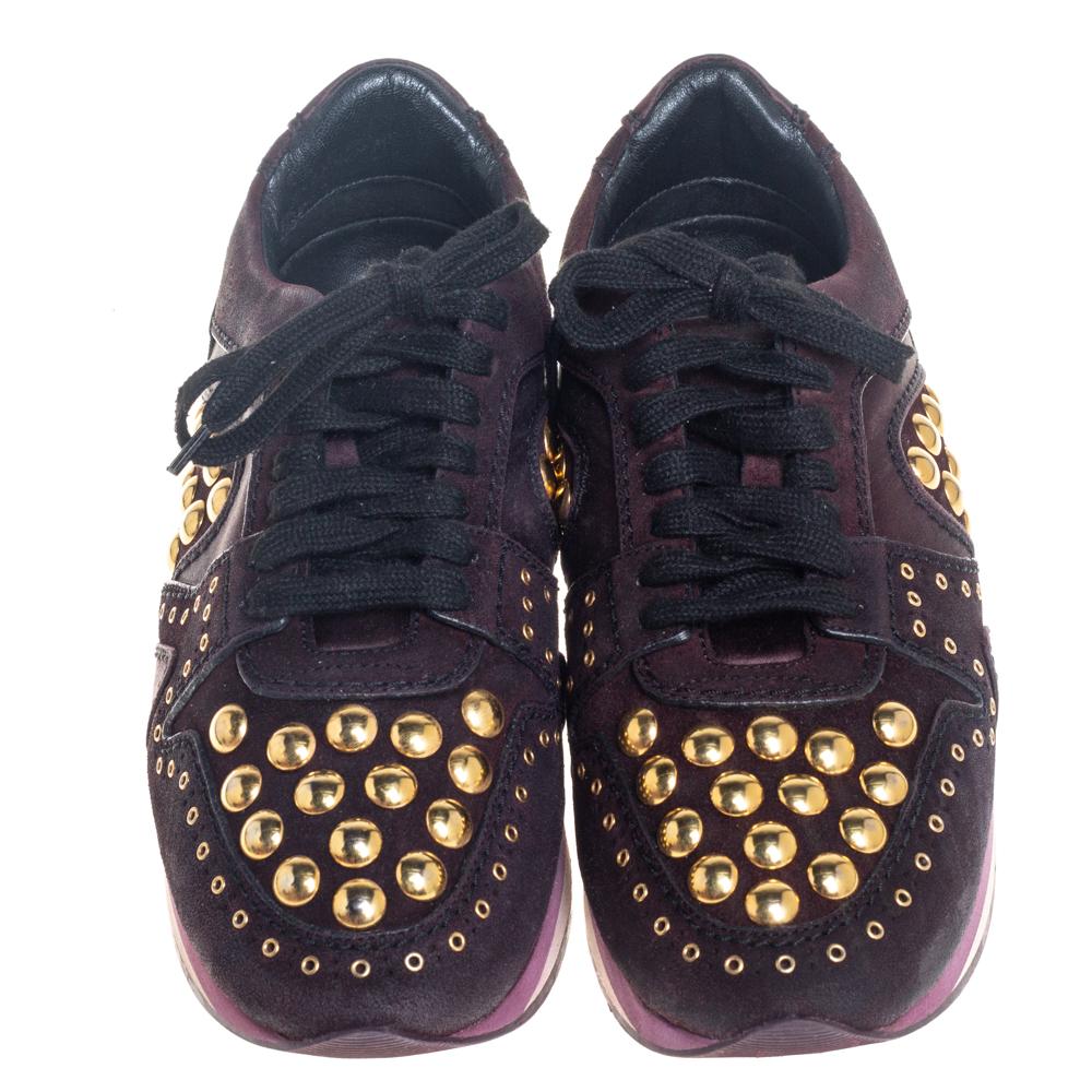 Let this pair of low-top Burberry sneakers elevate your style this season. Crafted from burgundy suede and satin, these sneakers feature round toes, lace-ups on the vamps, and gold-tone stud embellishments. They are made comfortable with