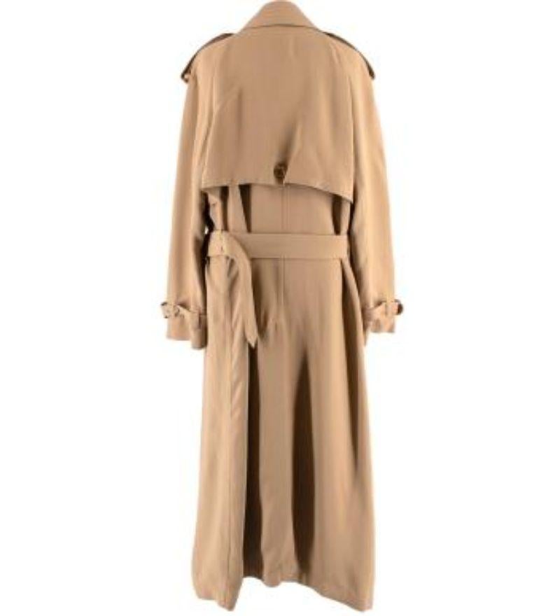Burberry Camel Silk Crepe Trench Coat

- Mid weight, silk crepe body 
- Shirt style collar
- Double breasted button and belt fastening
- Mid length 
- Fully lined with camel silk

Materials: 
Shell:
100% Viscose
Lining:
76% Acetate 
24% Silk 

Made
