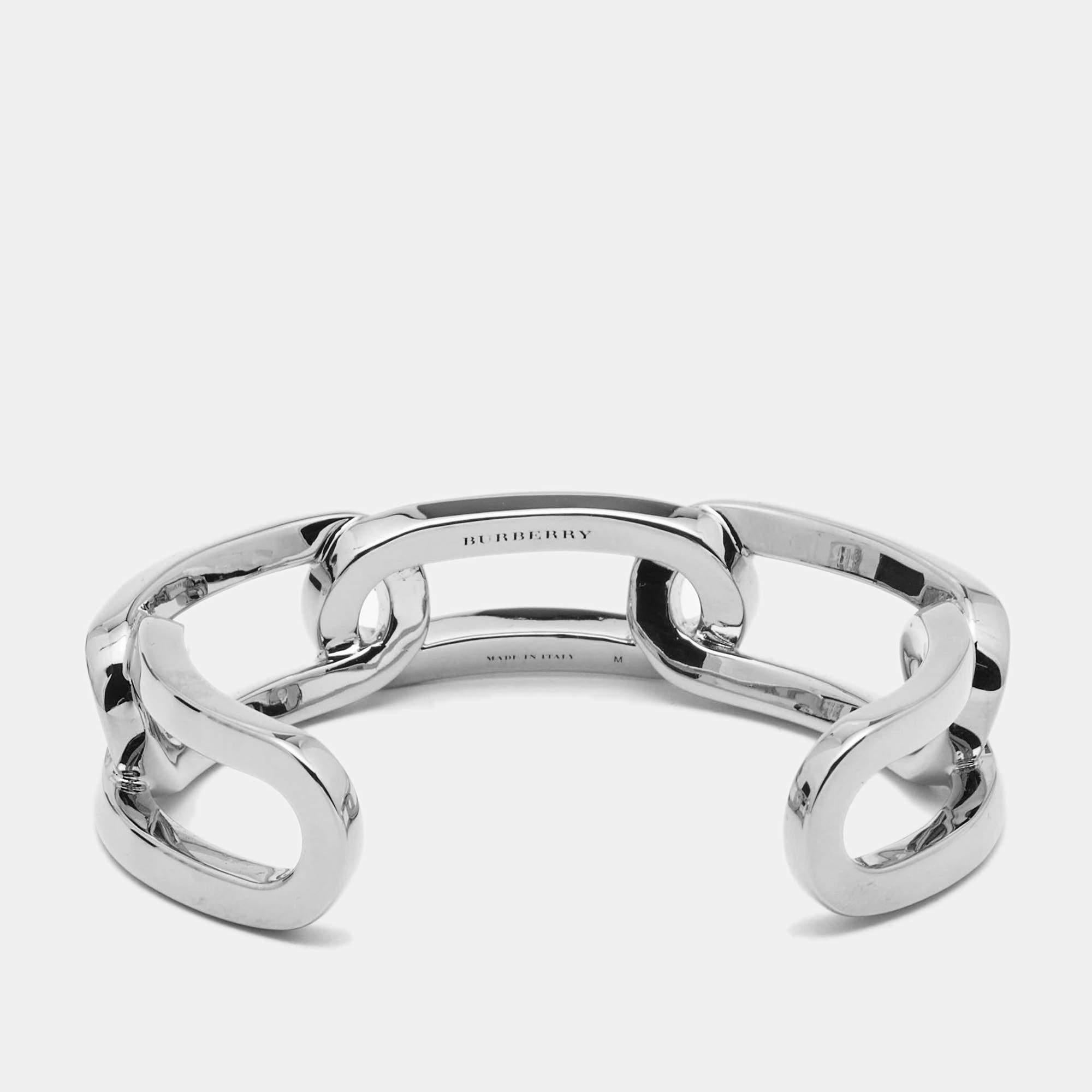 For the woman who is ready to ace every accessory game, Burberry brings her this fabulous open cuff bracelet made from silver-tone metal into a chainlink silhouette. The bracelet has a simple style with smooth edges and hallmark