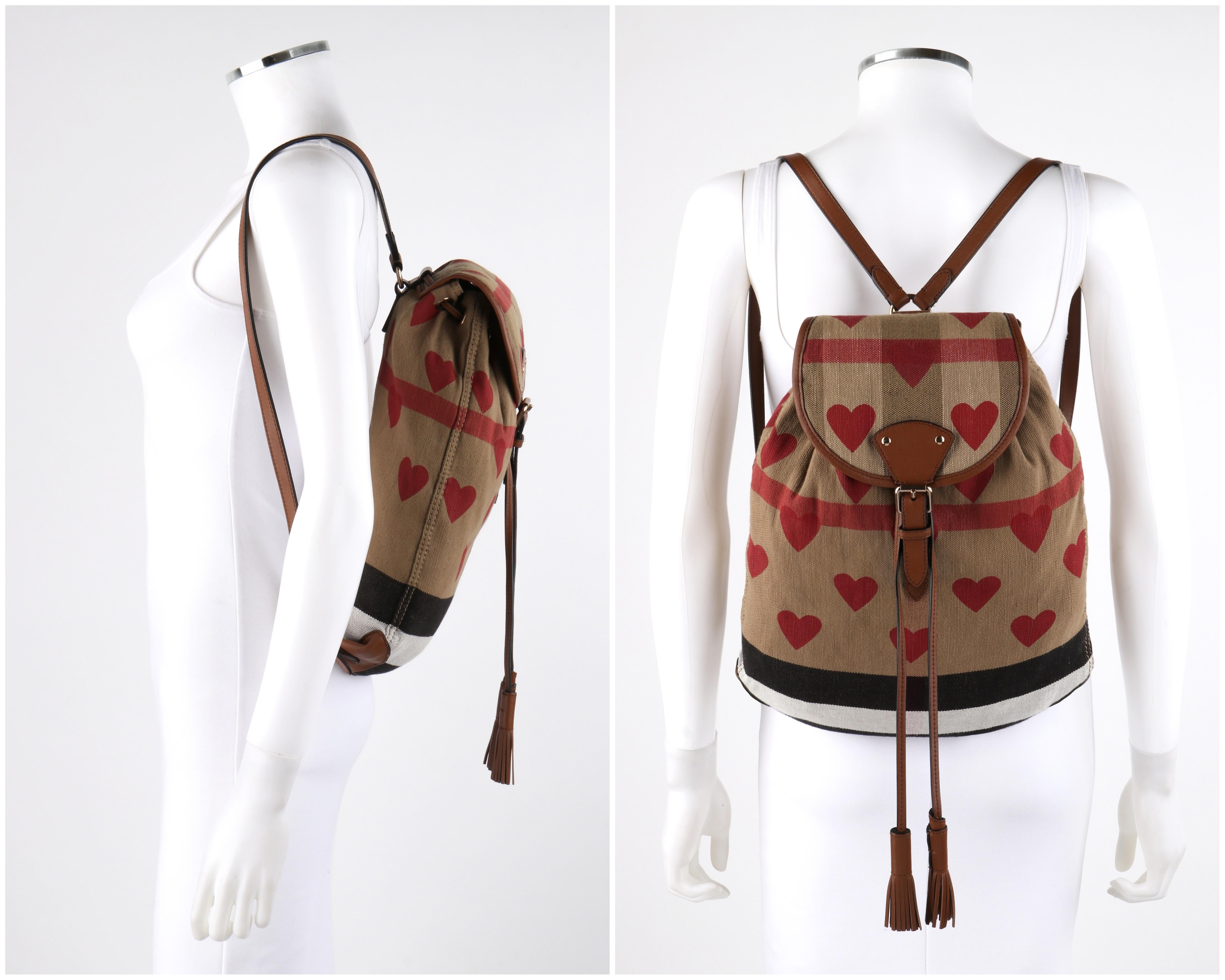 BURBERRY Chilton Check Hearts Canvas Leather Trim Backpack

Brand / Manufacturer: Burberry
Designer: Christopher Bailey
Style: Backpack Bag
Color(s): Shades of tan, red, white, black
Marked Materials: Exterior: 56% Jute; 44% Cotton; Trim: 100% Cow