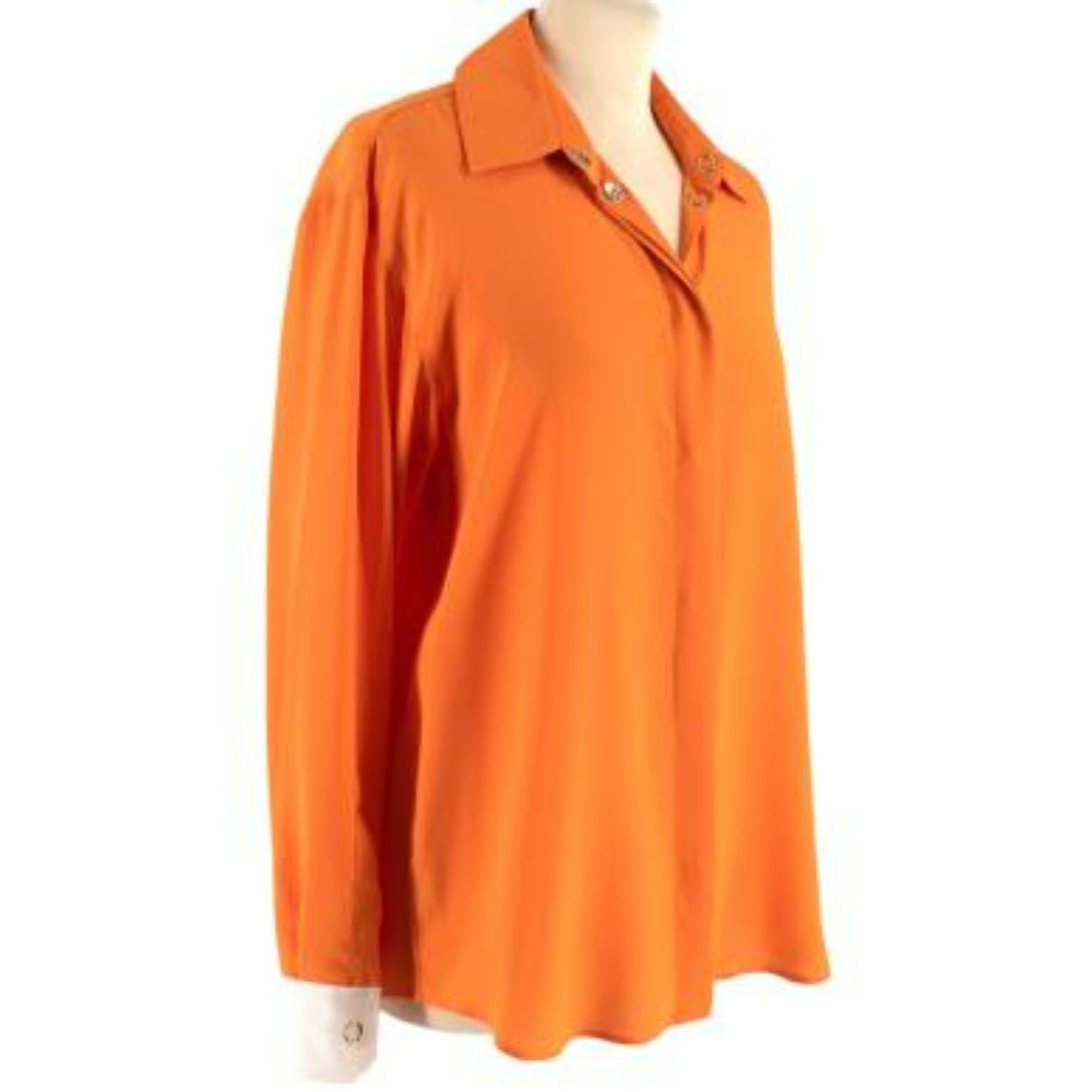 Burberry Orange and White Silk Shirt

- Light weight, fluid silk 
- Orange body 
- White tip cuffs 
- Concealed popper button stand 
- Loose fitting

Materials:
100% Silk

Made in Italy 

Dry clean only 

PLEASE NOTE, THESE ITEMS ARE PRE-OWNED AND