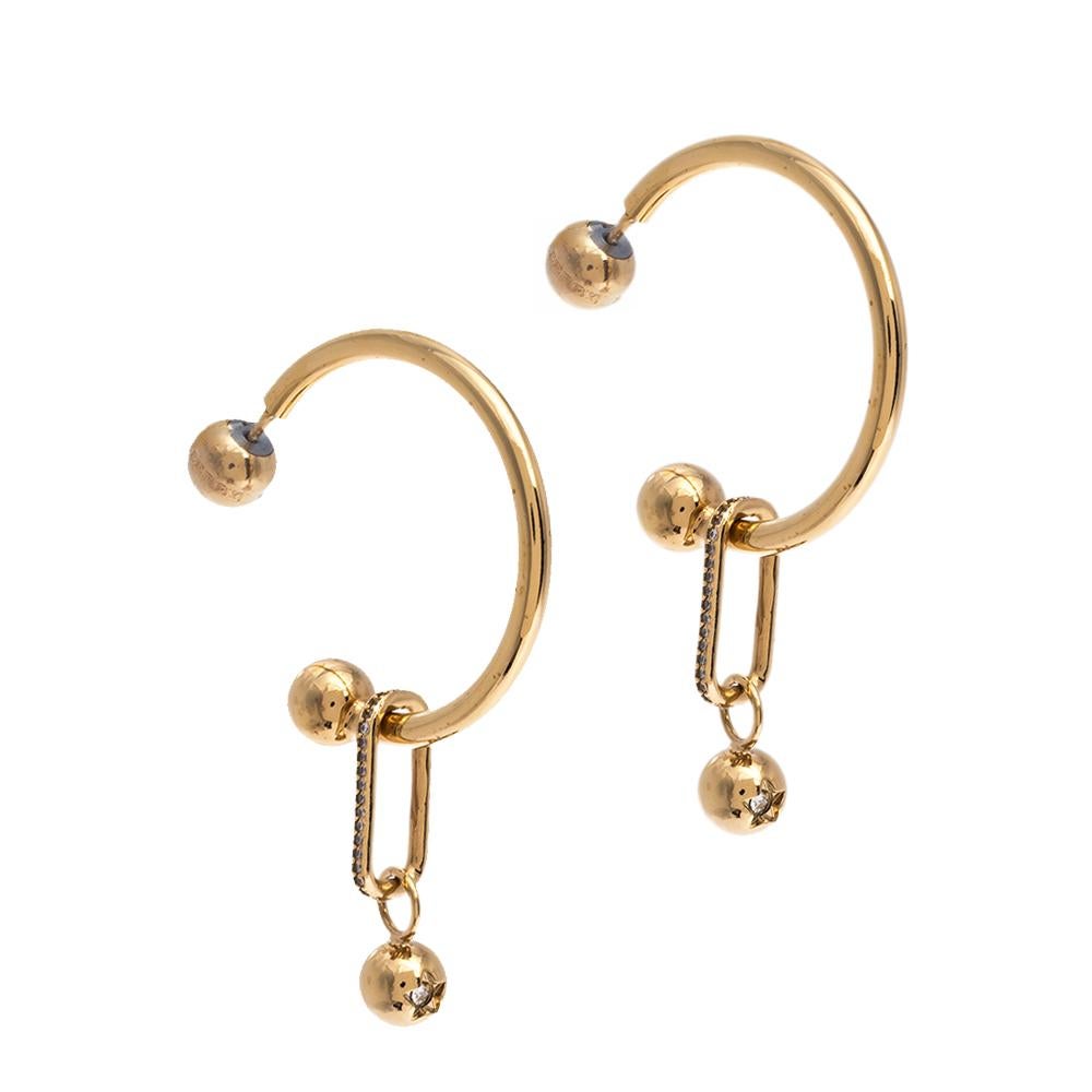 These stylish hoop earrings come from the house of Burberry. They are crafted from gold-tone metal into a lovely shape and are enhanced with crystals. The creation will look amazing with both your casual and formal outfits.

Includes: Price Tag
