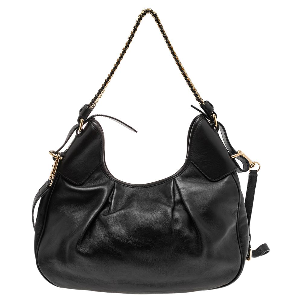 This beautifully stitched leather hobo is by Burberry. With a capacious canvas-lined interior, a comfortable handle, and a fine finish, this dark brown hobo is bound to offer style and practical ease.

Includes: Strap
