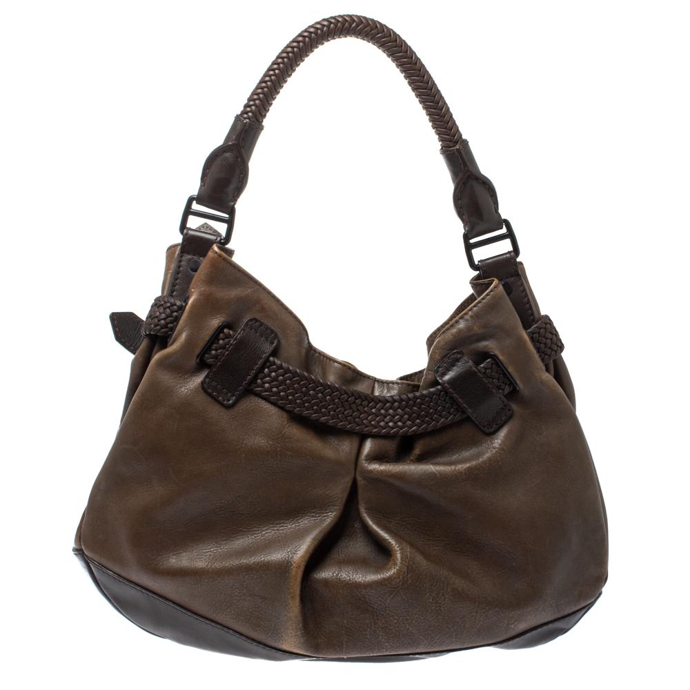 Crafted from fine brown-hued leather, this elegant Burberry hobo features a fabric interior. This slouchy bag features an embossed brand label and an equestrian buckle clasp on the front. The black-tone hardware and single rolled handle give this