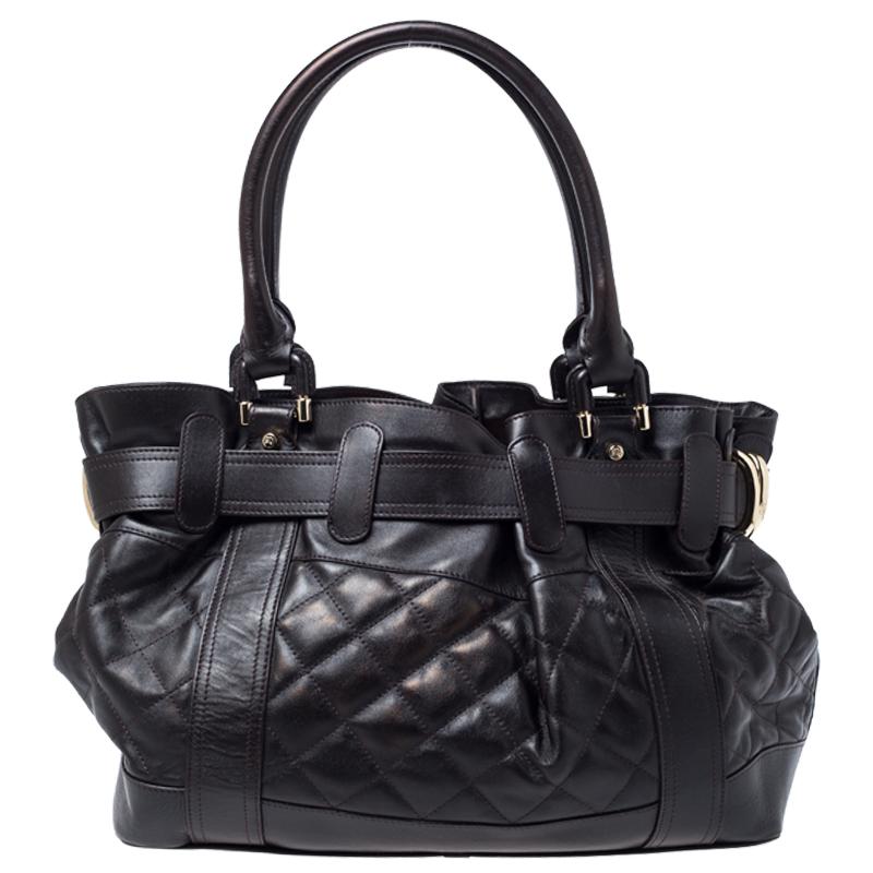 Complete a stylish look with this beautiful Beaton tote from Burberry. The leather exterior has been adorned with a quilted pattern and belt detailing, giving the piece a unique touch. It features dual handles and has a nylon lined interior that