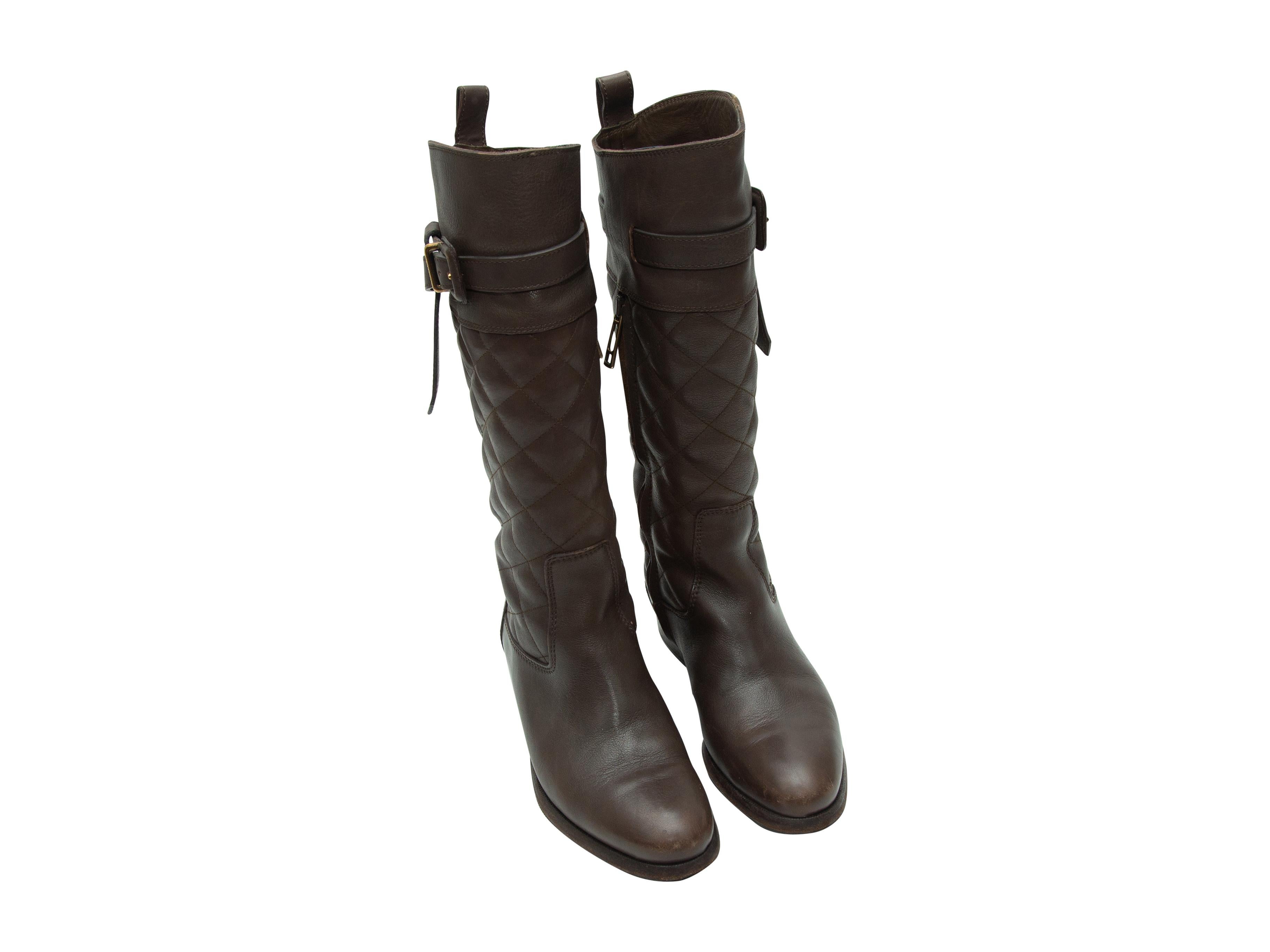 Product details: Dark brown quilted leather tall boots by Burberry. Gold-tone buckle accents at tops. Stacked heels. Zip closures at inner sides. Designer size 36. 1