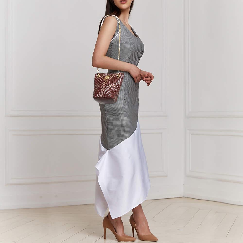 Brimming with artistry and quality craftsmanship  it is designed in a bucket silhouette  and the interior is spacious enough to hold all your essentials. This beautiful piece deserves to be carried with style by you.