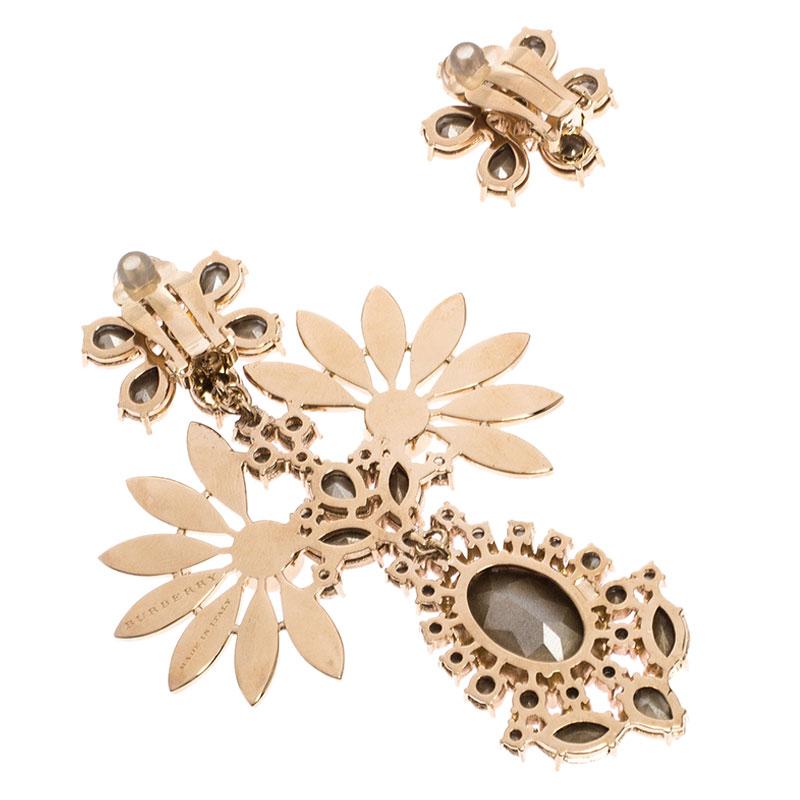 Mismatched, sparkly and breathtaking! These asymmetric earrings from Burberry tugs at one's heartstrings in the most profound way. Sculpted from gold-tone metal and lit by crystals, the pair comes as stud flowers but one of them has an exaggerated