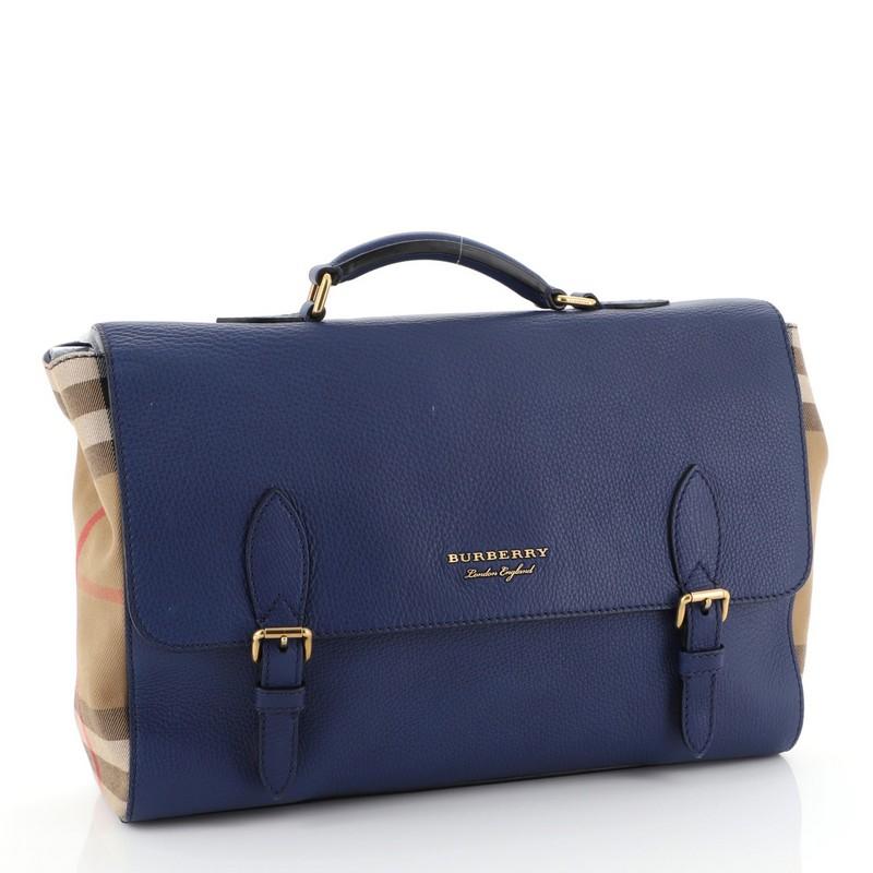 This Burberry Ethan Briefcase Leather and House Check Canvas Medium, crafted from blue leather and house check canvas, features leather top handle, exterior back zip pocket, and gold-tone hardware. Its flap with buckle closure opens to a black
