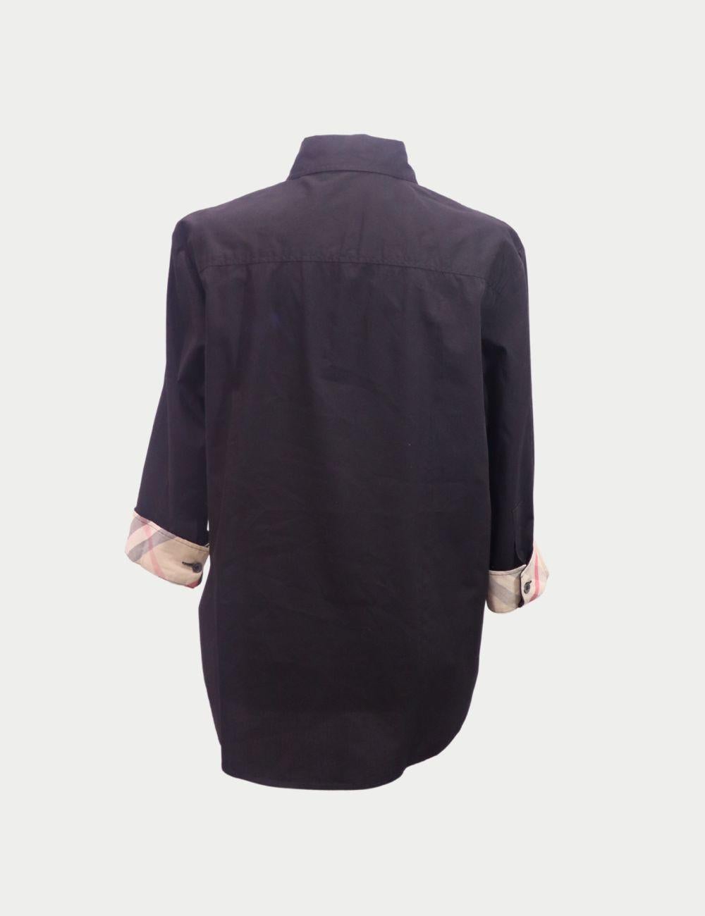 Burberry Black Cotton Shirt with Signature Check Cuffs

Elevate your wardrobe essentials with this classic black button-up shirt by Burberry. Tailored from soft, breathable cotton, this shirt features a sharp collar, full front button closure, and