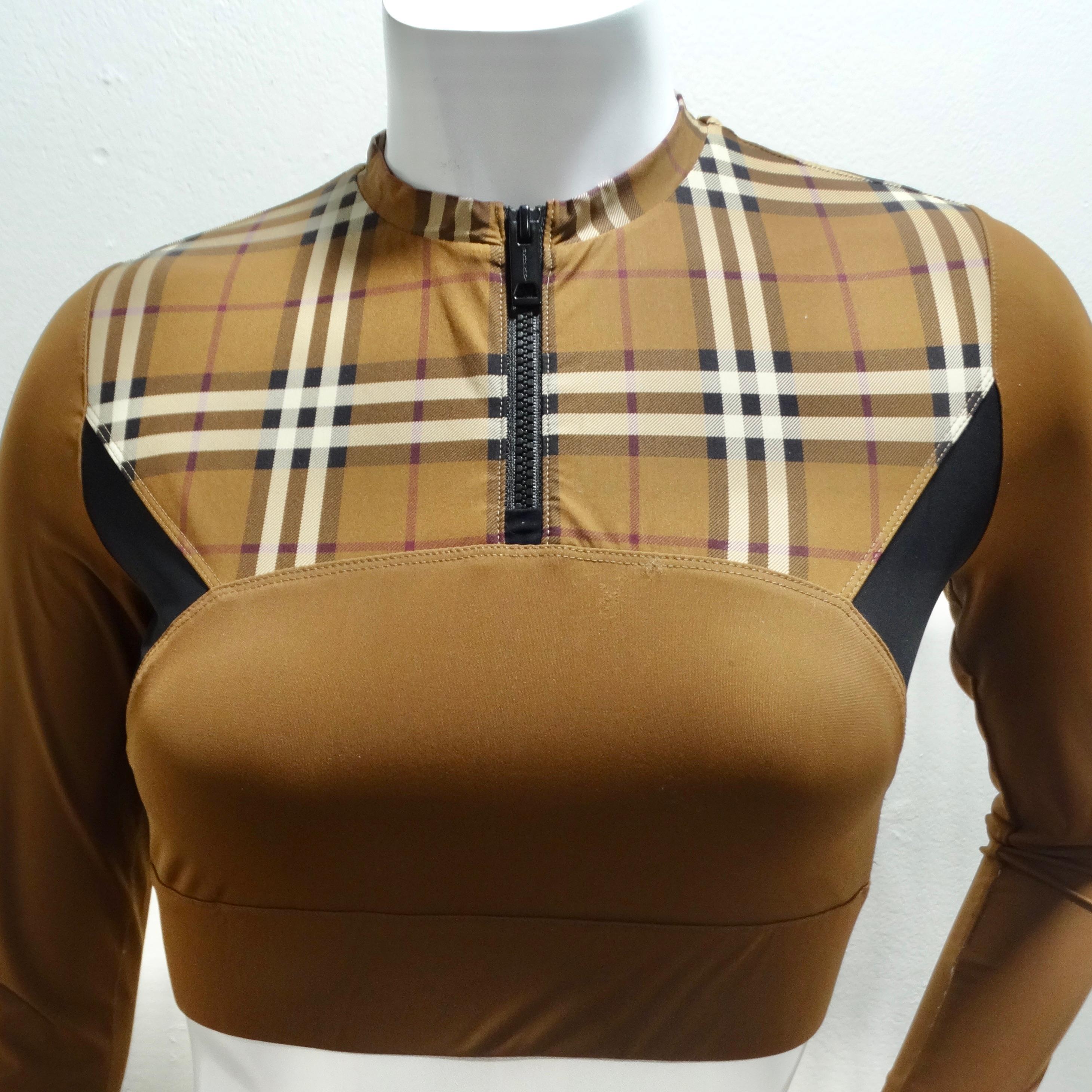 Introducing the Burberry Everley Check Sporty Top – a versatile and stylish addition to your wardrobe that seamlessly transitions from workout wear to chic casual attire. Crafted in a light brown hue, this long sleeve cropped top is designed for