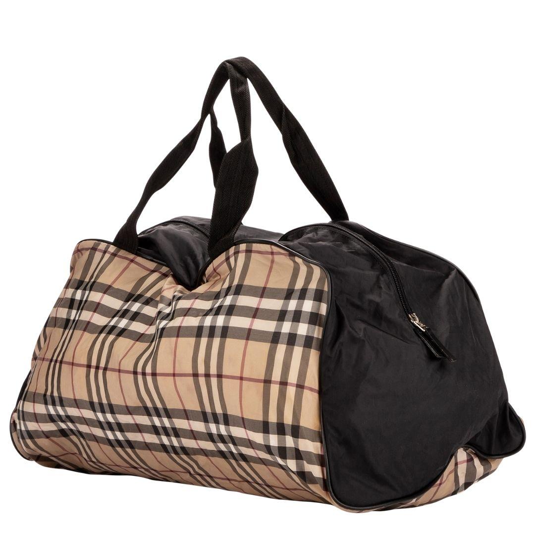 The travel tote you never knew you needed! Crafted in the iconic Burberry check nylon, silver hardware, and double black nylon straps. The zipper closure opens to a roomy nylon interior. The best part? Fold up your tote and slip it inside the
