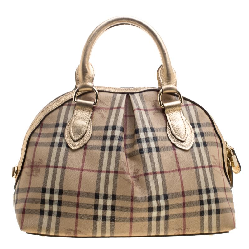 Spacious and captivating, this Thornley Bowling bag is from Burberry. It has been crafted from their signature Haymarket check PVC and accented with leather trims and gold-tone hardware. It comes with dual rolled handles and the zip top closure