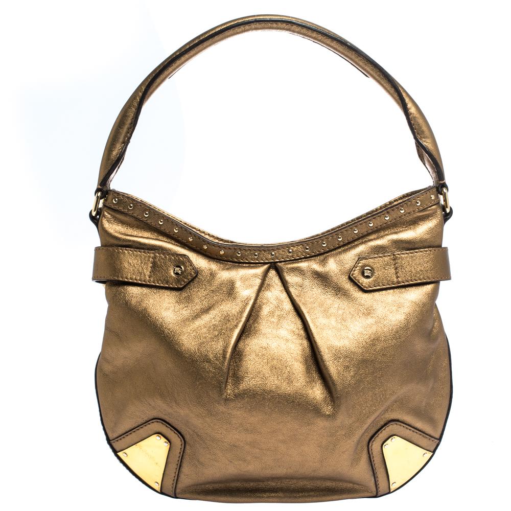 Displaying perfect designs, this Burberry hobo bag is a closet staple and stands out. Crafted from quality leather, it comes in a lovely shade of gold. It has a slouchy silhouette, single handle, stud & buckle detailing, brand log in the front and