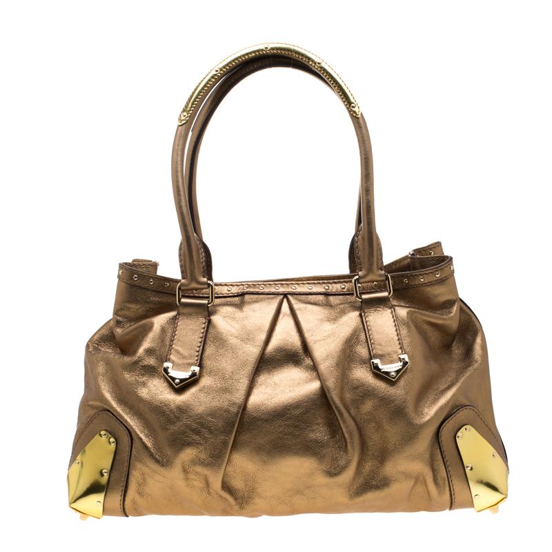 This satchel from Burberry is crafted from metallic gold leather. It has two handles, metal corners, and a snap button that opens to a fabric-lined interior. Grand in design, the bag is perfect for everyday use.

Includes: The Luxury Closet