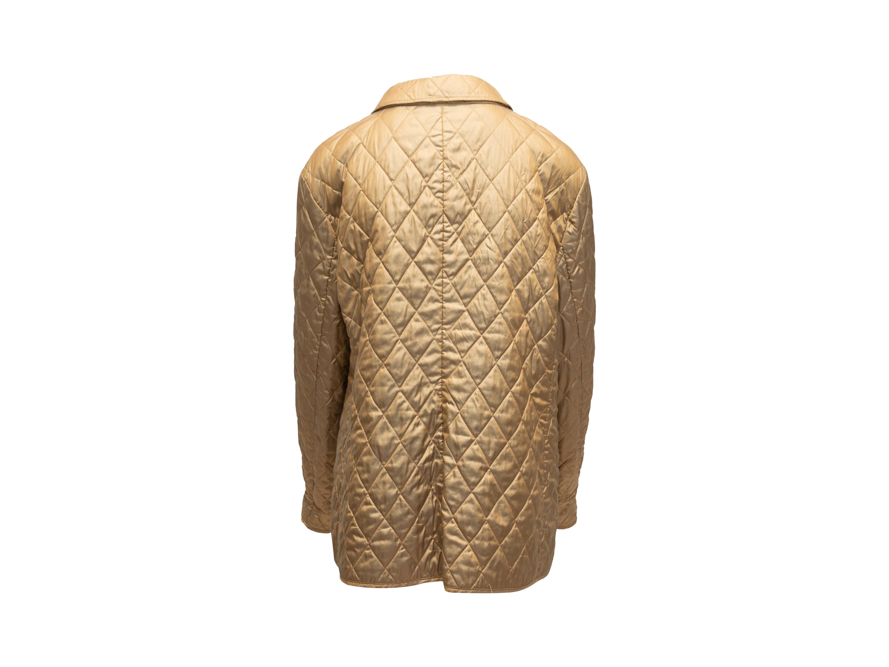 Product details: Gold quilted jacket by Burberry. Pointed collar. Dual hip pockets. Nova Check lining. Button closures at center front. 46