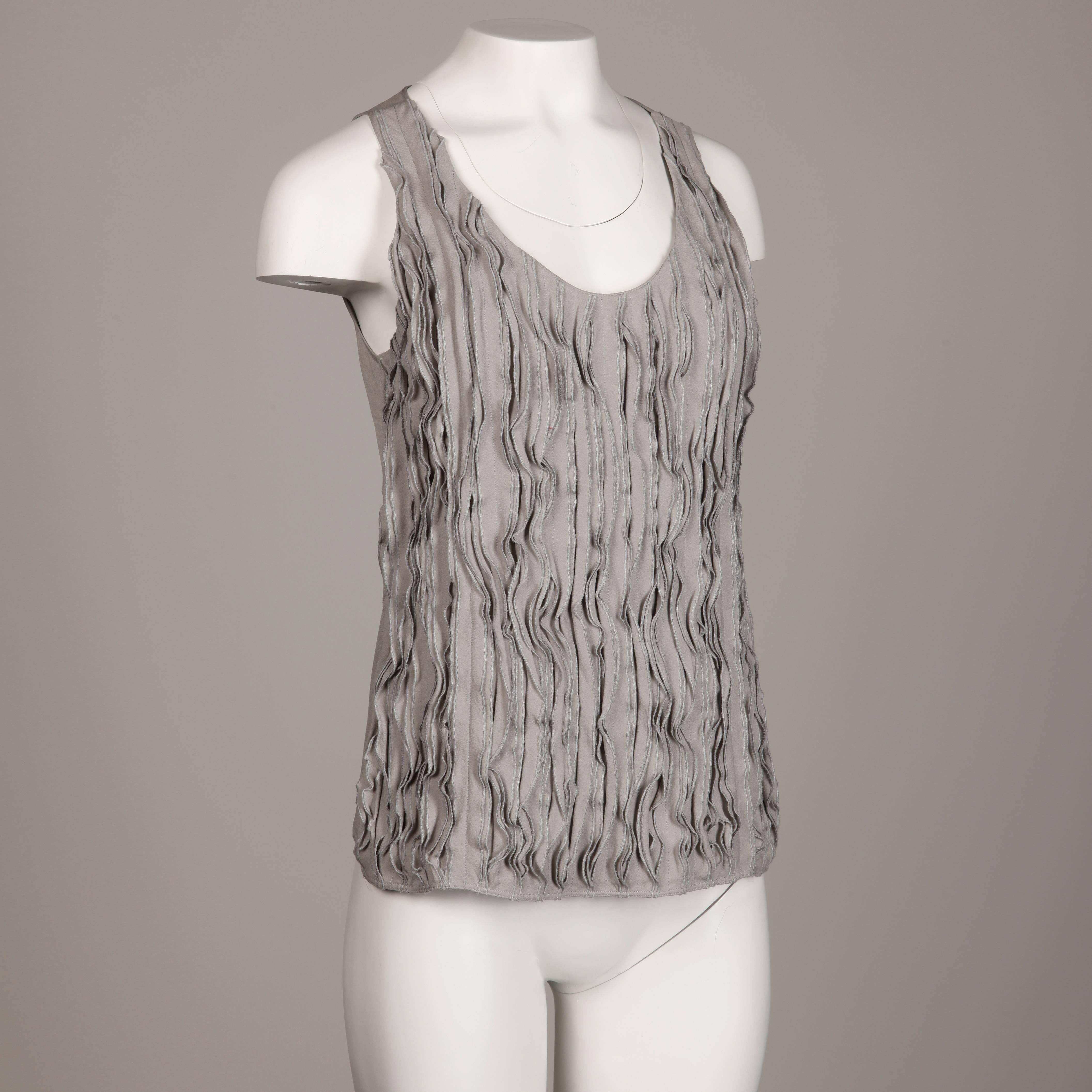 Recent Burberry tank top with a ruffled design in front. 100% silk fabric with side zip and hook closure. Marked size is USA 4/ UK 6 and fits like a modern size small. The bust measures 35