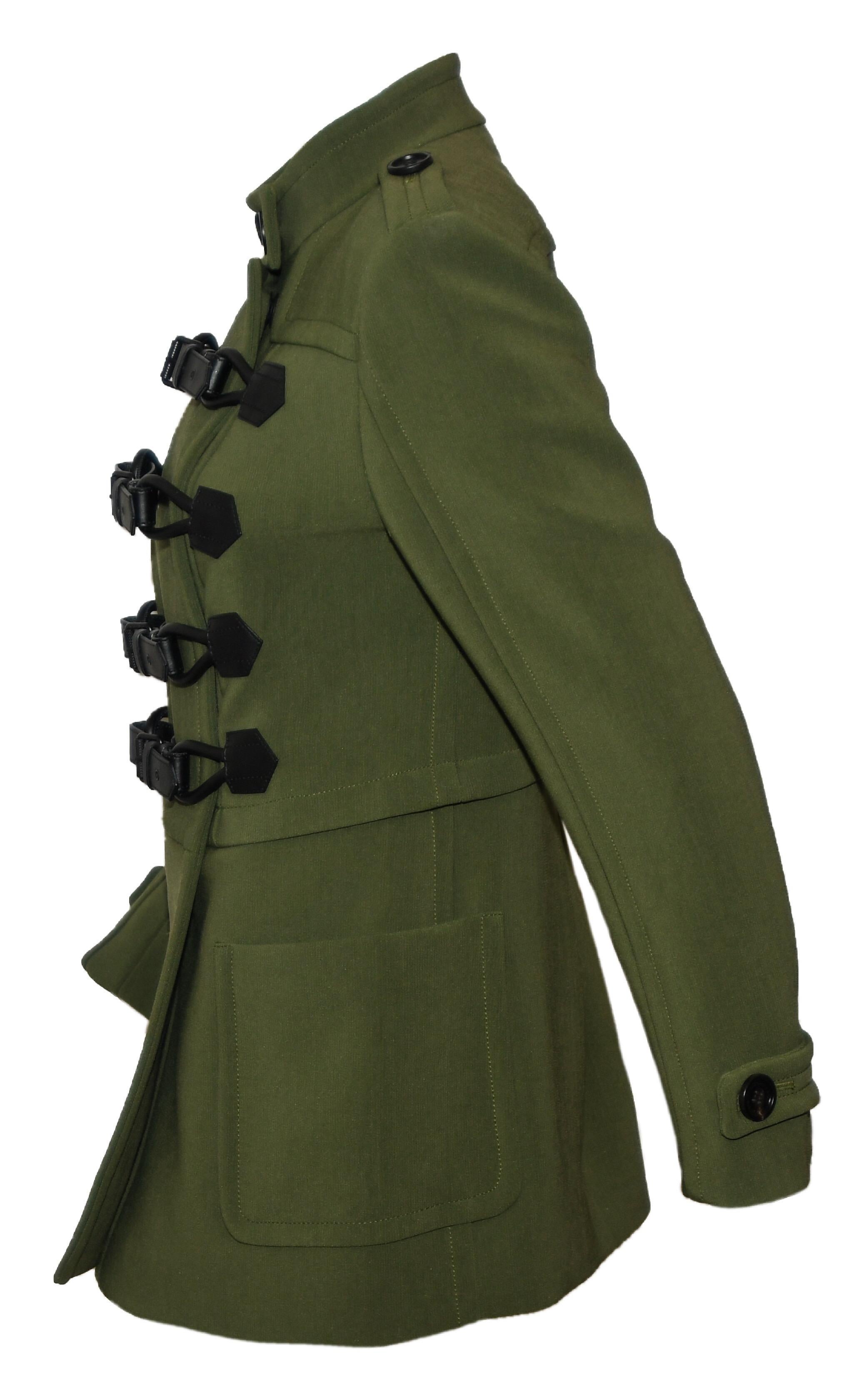 Burberry military green jacket includes 4 black leather belts & buckles for closure, at front.  This Burberry long jacket is typical brit heritage label as it continues its bid for global domination. It certainly suggested that they are on track.