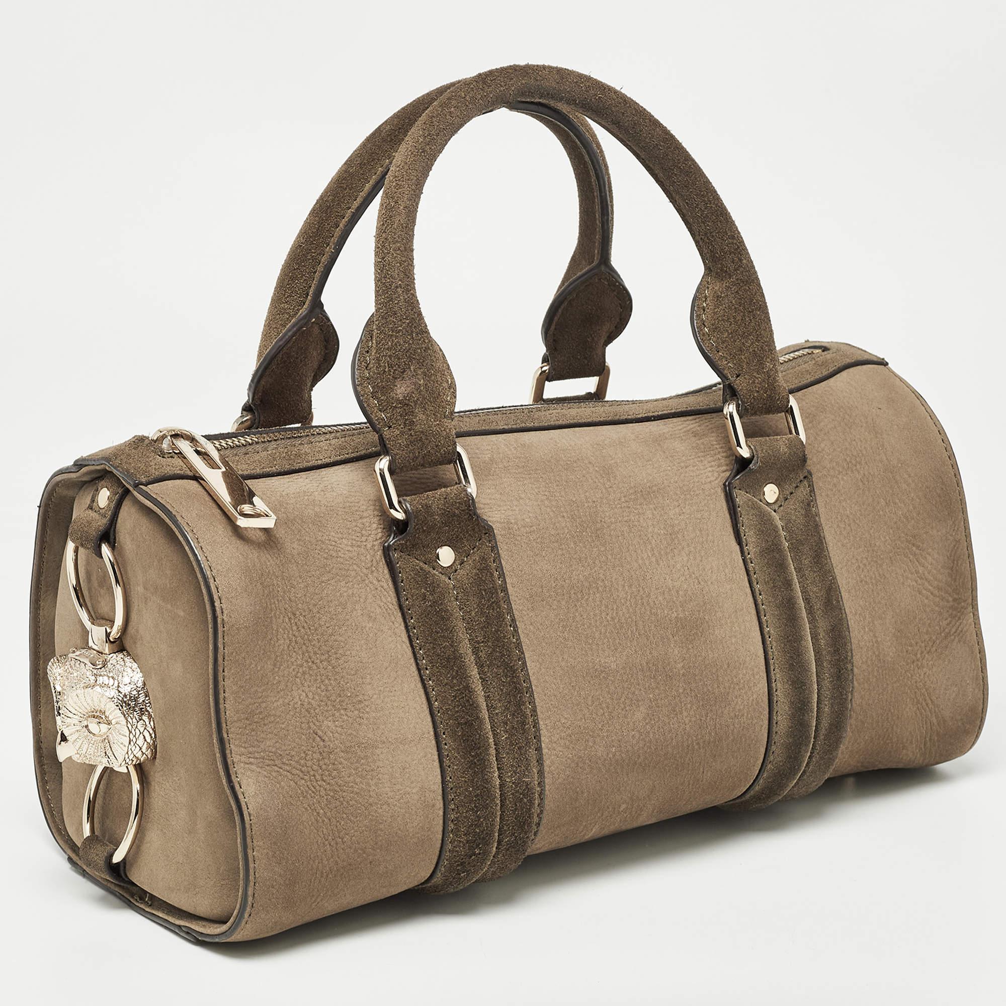 Elevate your style with this Burberry duffel bag. Merging form and function, this exquisite accessory epitomizes sophistication, ensuring you stand out with elegance and practicality by your side.

