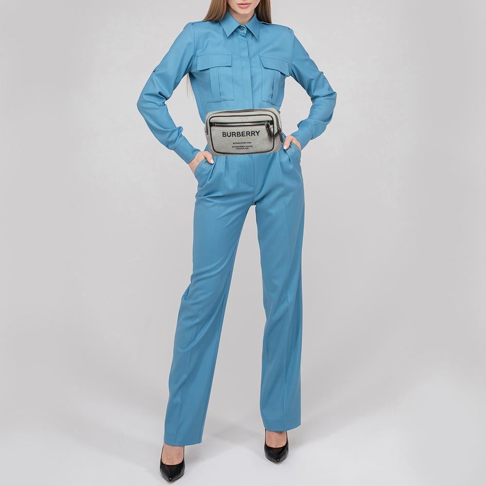This West belt bag from the House of Burberry will help you obtain a comfortable and classy style! Designed using leather and canvas, this bag showcases silver-tone fittings with a spacious interior. Carry your belongings stylishly in this smart