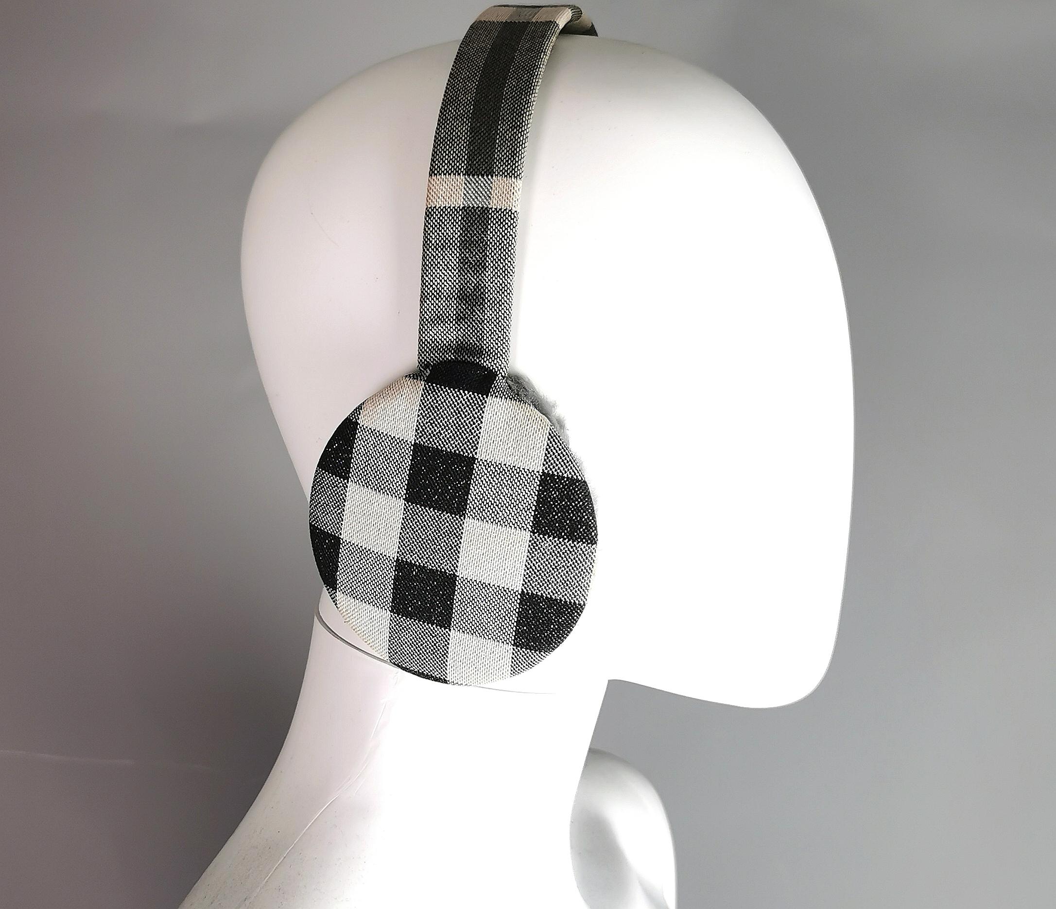 A stylish pair of vintage Burberry ear muffs.

Keep warm in style with this lovely pair of ear muffs, they feature the signature Burberry check pattern in a muted grey, black and off white colour.

They have a soft grey faux fur lining to the ear