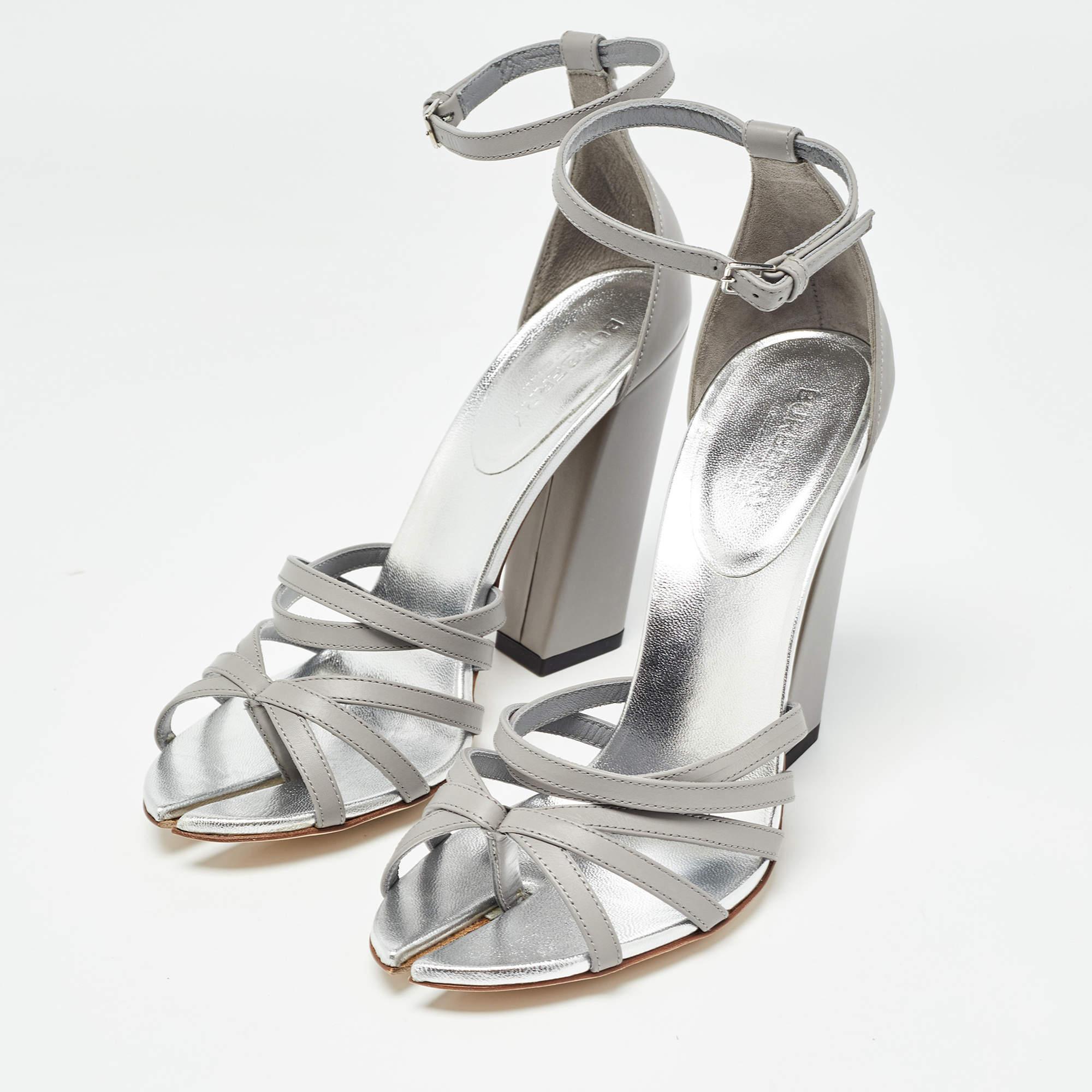 These sandals from Burberry are edgy and sleek at the same time. They have been crafted from leather and designed beautifully with cutout on the toes red leather lining strappy vamps and 11 cm block heels. They are made complete with buckled ankle