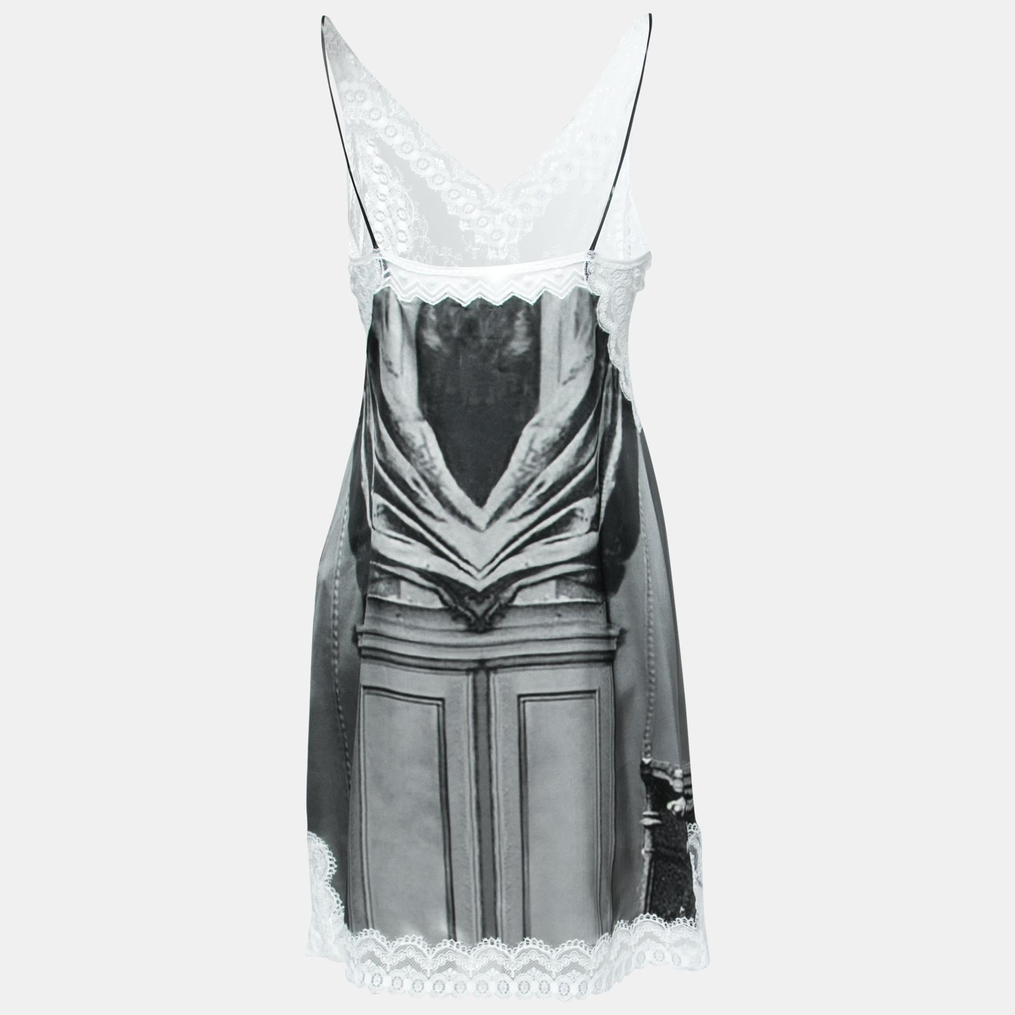 Burberry's incorporation of Victorian aesthetics with fine lacy installations makes dreams come true for so many fashion enthusiasts. In this gorgeous slip dress, you can witness a grey Victorian Portrait printed on the silk fabric, lace insets, and