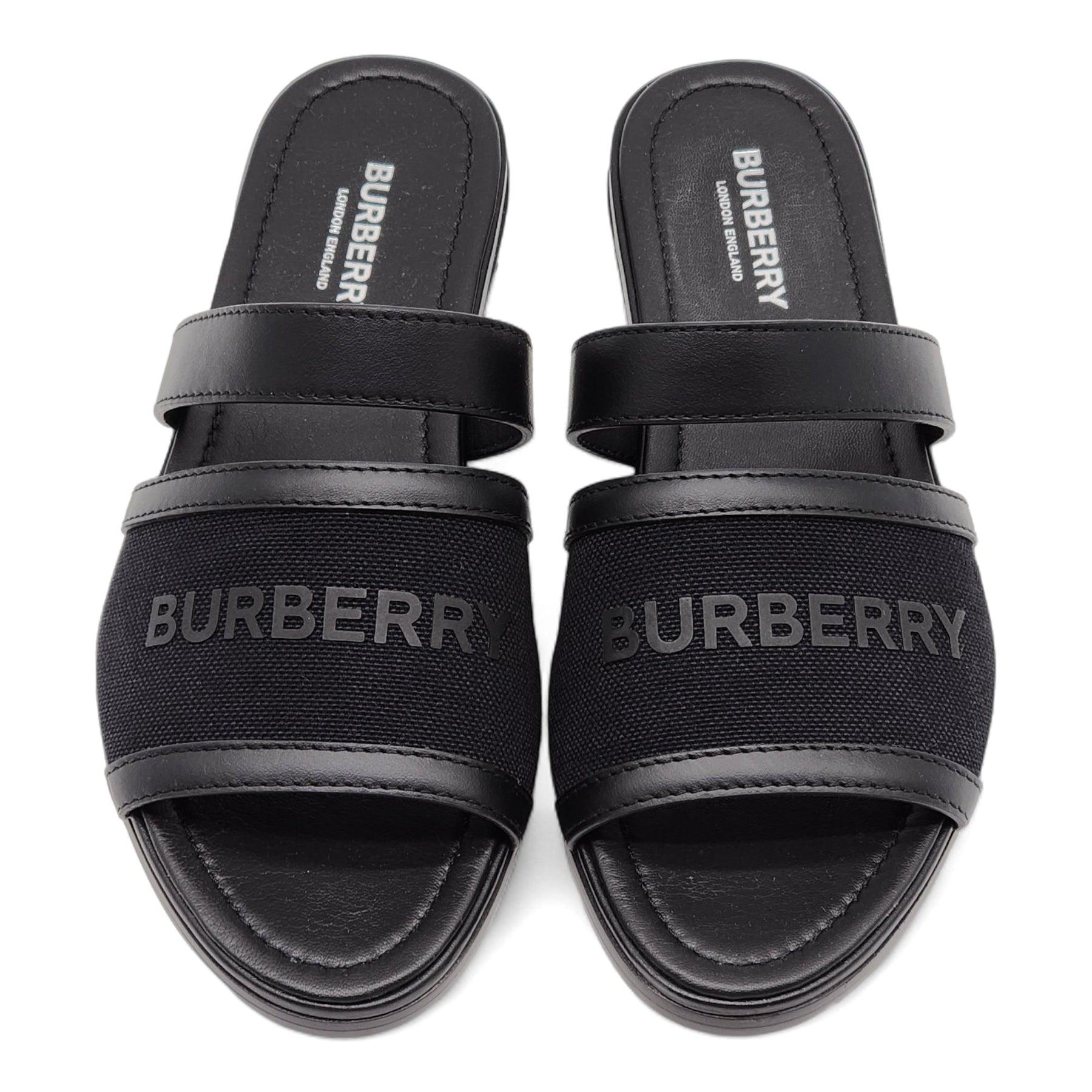 Burberry Honour Canvas and Leather Flat Sandals in Black.

Additional information:
Material: Canvas & leather
Color: Black
Size: 6 US
Country: Italy
Condition: Brand new with box.
Available in other size: 6.5 US
