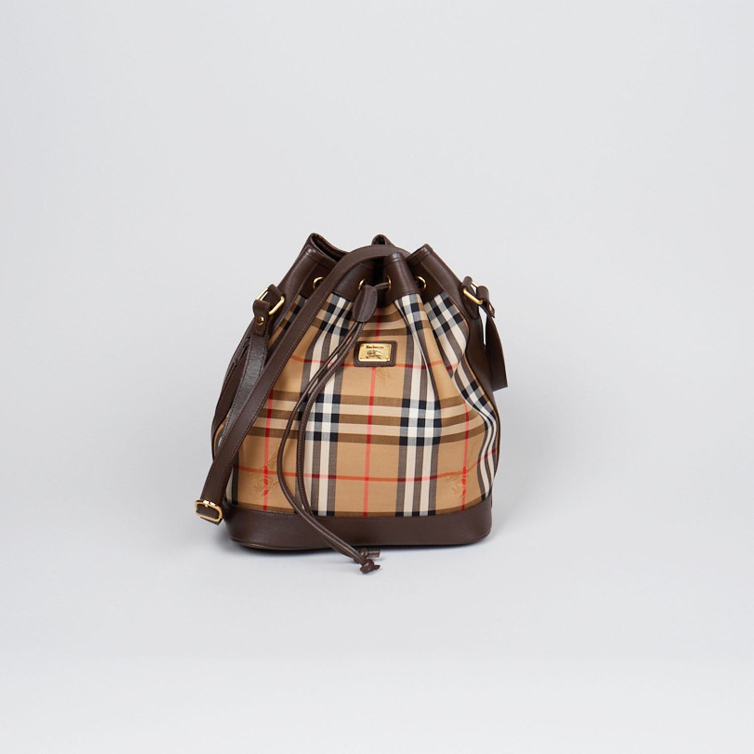 Tan and brown Horseferry Check canvas Burberry London bucket bag with

- Gold-tone hardware
- Adjustable flat shoulder strap
- Brown leather trim
- Chocolate leather lining, single pocket at interior wall and drawstring closure at top

Overall