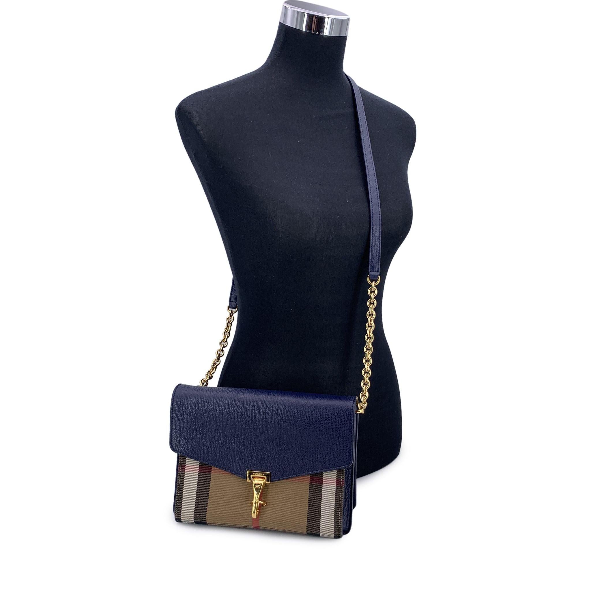This beautiful Bag will come with a Certificate of Authenticity by Entrupy. The certificate will be provided at no further cost The Burberry House Check Canvas Blue Leather Small Macken Crossbody Bag is a perfect blend of classic style and modern