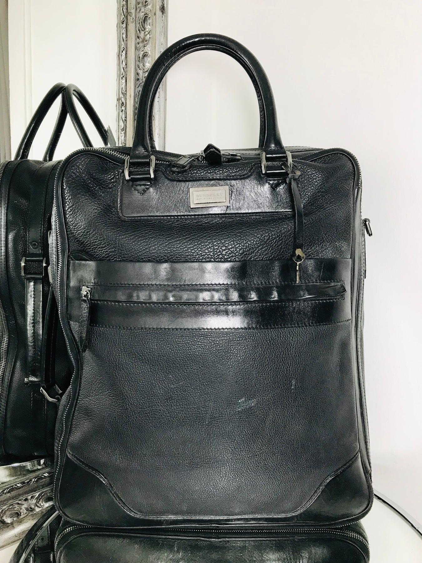 Black Leather Travel Bag by Burberry

Round top carry handles and removable, adjustable shoulder strap. Two front zip pockets and multiple interior pockets. Two large interior compartment. Black metallic hardware and padlock.

Additional