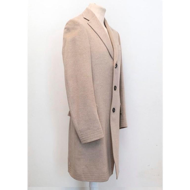 Burberry - 

Light beige long coat, three button down coat. Buttons have slight discolouration, there are two faded marks in the sleeve (photo 9) and there are some white tiny marks on the inside lining next to the label please refer to image 6 to