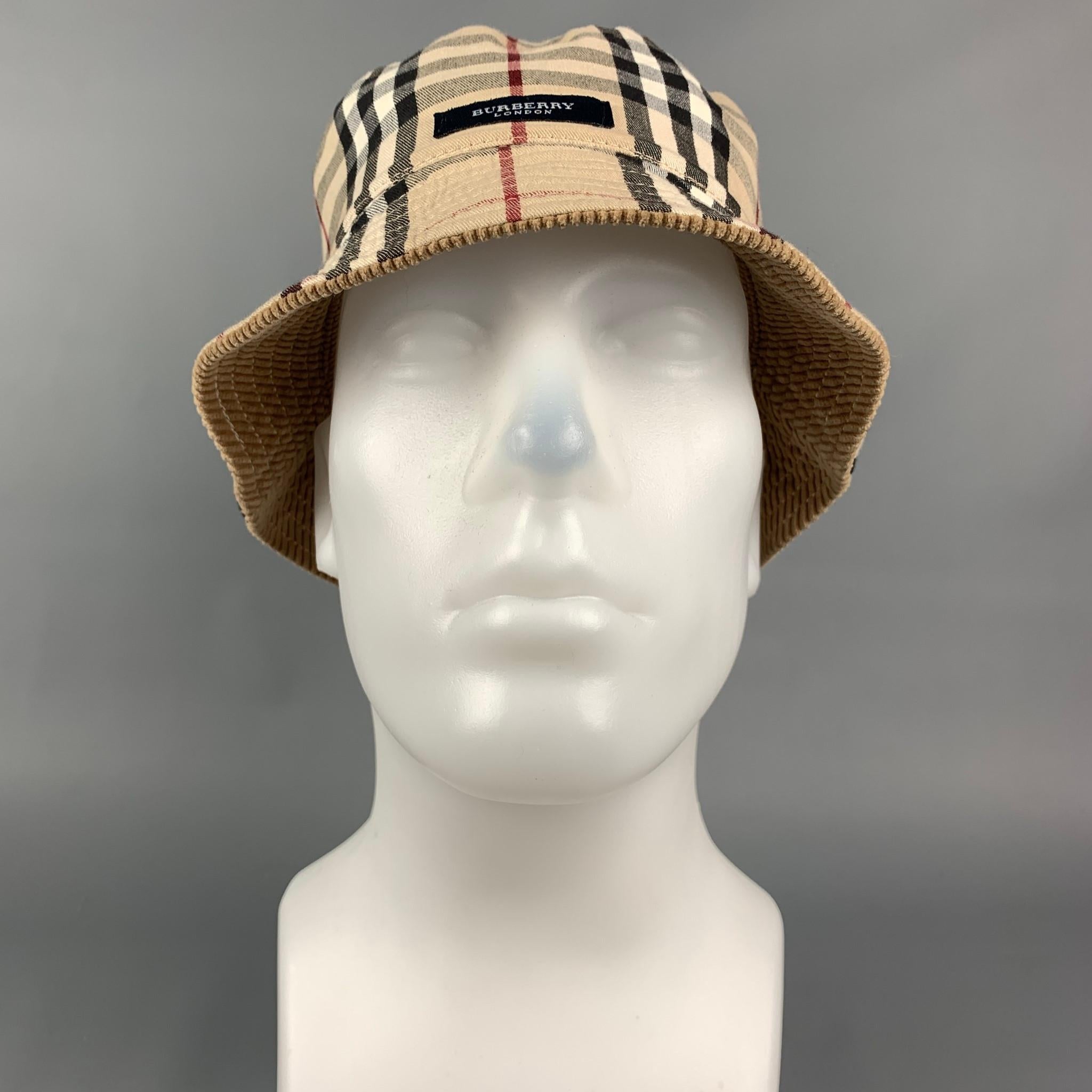 BURBERRY LONDON bucket hat comes in a beige & tan plaid cotton featuring a corduroy reversible style. 

Very Good Pre-Owned Condition.
Marked: Size tag removed.
Original Retail Price: $420.00

Measurements:

Opening: 22 in.
Brim: 2 in.
Height: 4 in. 