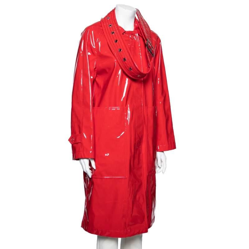 Incorporate a dash of red into your attire with this fabulous coat from Burberry London. It is designed using red faux leather, which is augmented with a belt embellishment. It comes with buttoned closures and long sleeves. Make an impressive