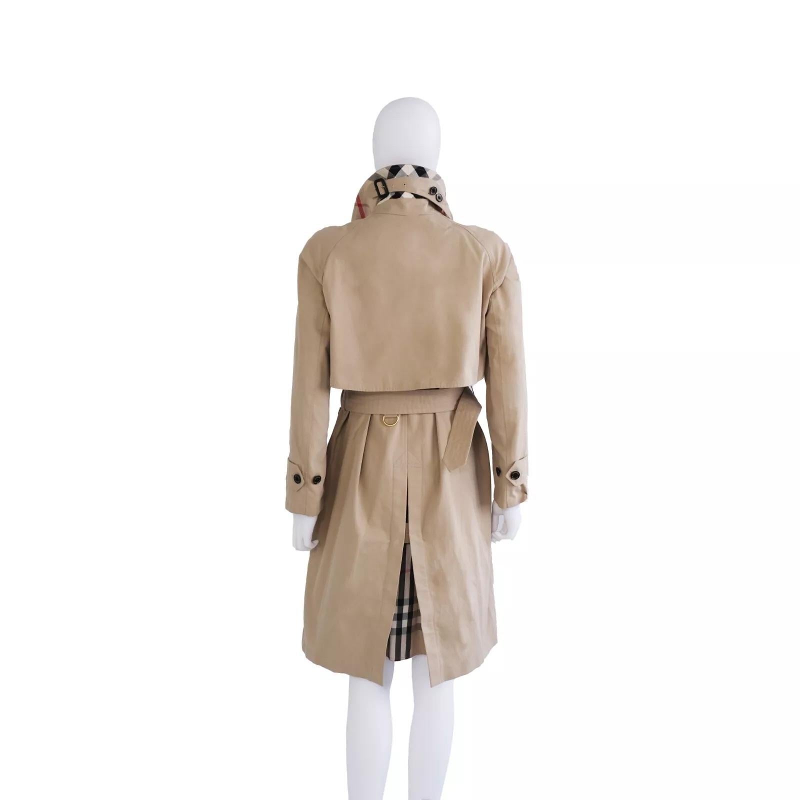 Brand: Burberry London 
Size: US 2 UK 4 Europe 36
Color: Beige / Honey 
Condition: Pre-owned, Great condition.
 
Features:
Belted waist for a flattering, tailored silhouette
Unique light blue statement buttons for a modern touch
Adjustable sleeve