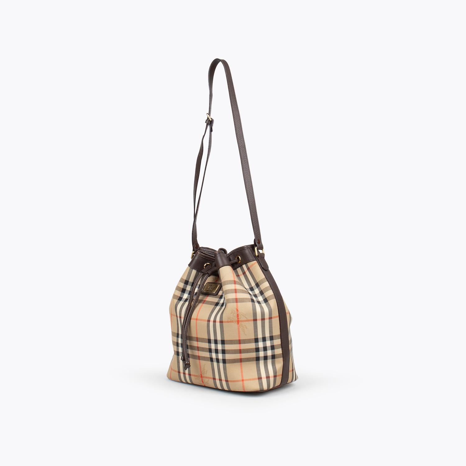 Tan and brown Horseferry Check canvas Burberry London bucket bag with

- Gold-tone hardware
- Adjustable flat shoulder strap
- Brown leather trim
- Chocolate leather lining, single pocket at interior wall and drawstring closure at top

Overall
