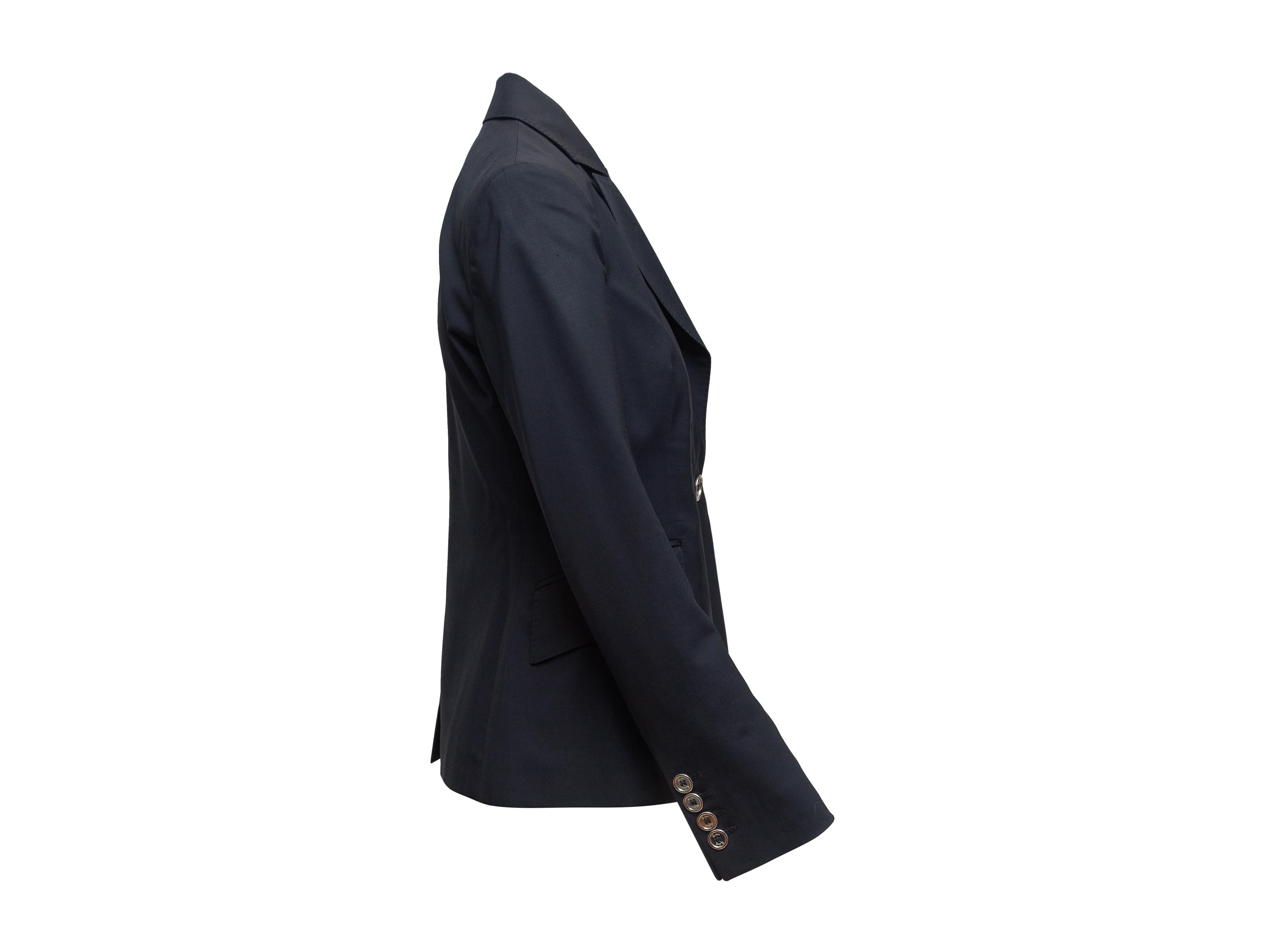 Product details: Midnight blue virgin wool Bromwell blazer by Burberry London. Peaked lapel. Single welt pocket at bust. Dual flap pockets at hips. Single button closure at front. 34