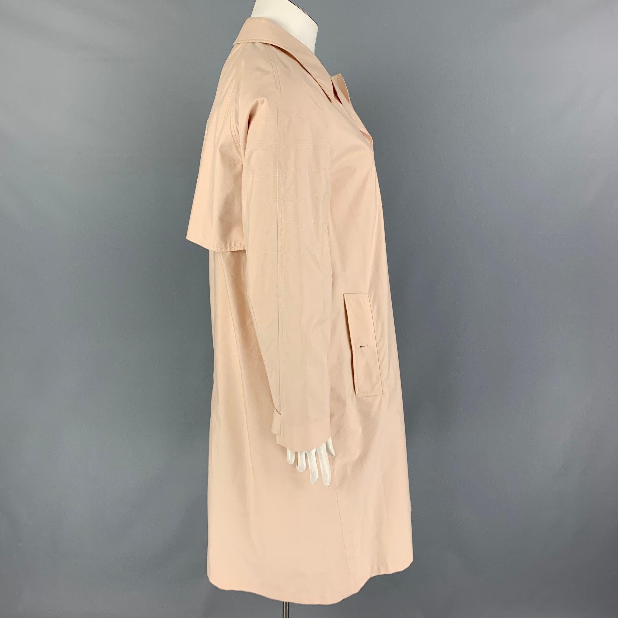 BURBERRY LONDON coat comes in a cream material featuring a oversized fit, notch lapel, slit pockets, single back vent, and a hidden placket closure. Very Good
Pre-Owned Condition. 

Marked:   UK 12 / US 10 / IT 44 

Measurements: 
 
Shoulder: 17