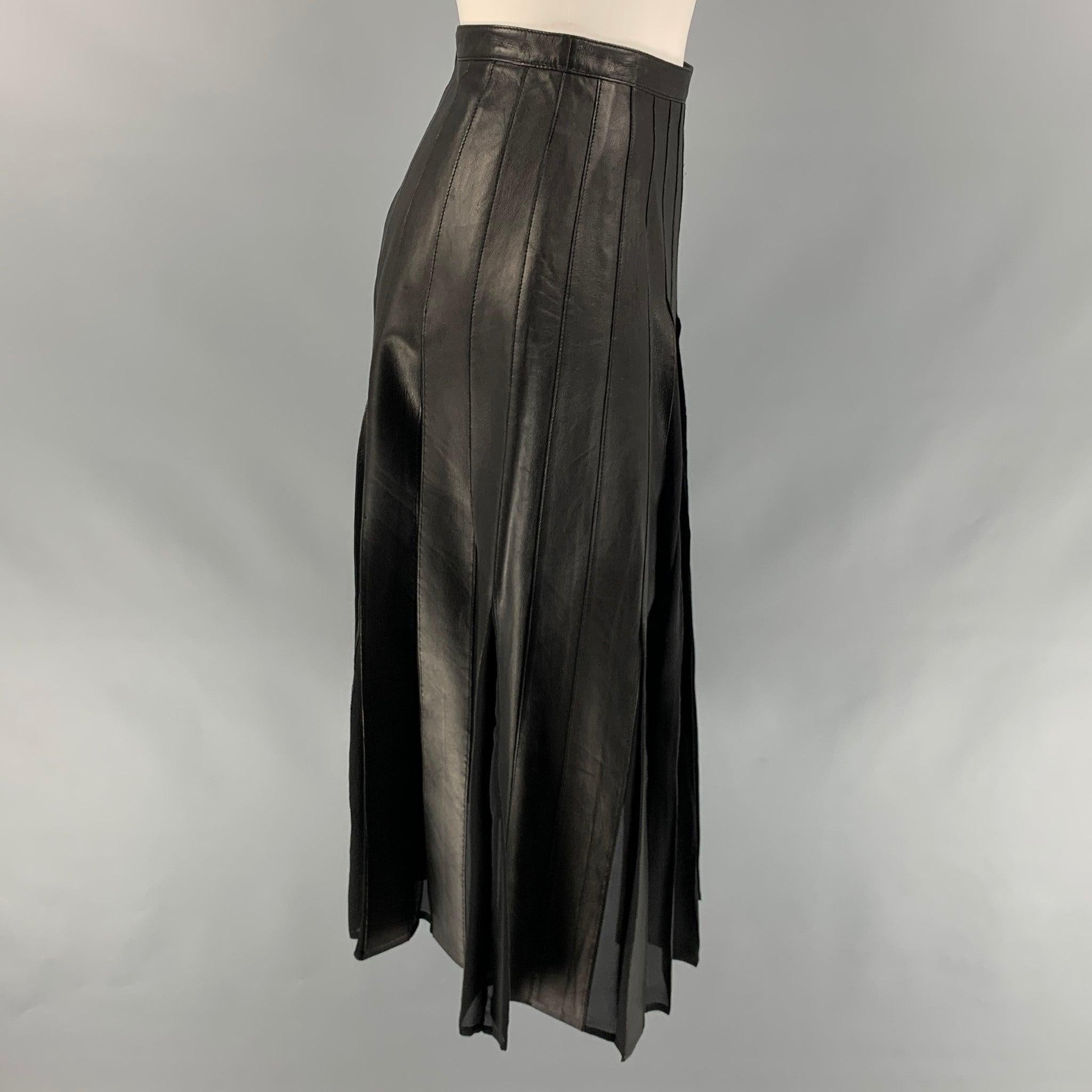 BURBERRY LONDON skirt comes in a black silk / leather featuring a pleated style, mid-calf, and a back zip up closure.
Very Good
Pre-Owned Condition. Fabric tag removed.  

Marked:   Size tag removed.  

Measurements: 
  Waist: 24 inches  Hip: 32